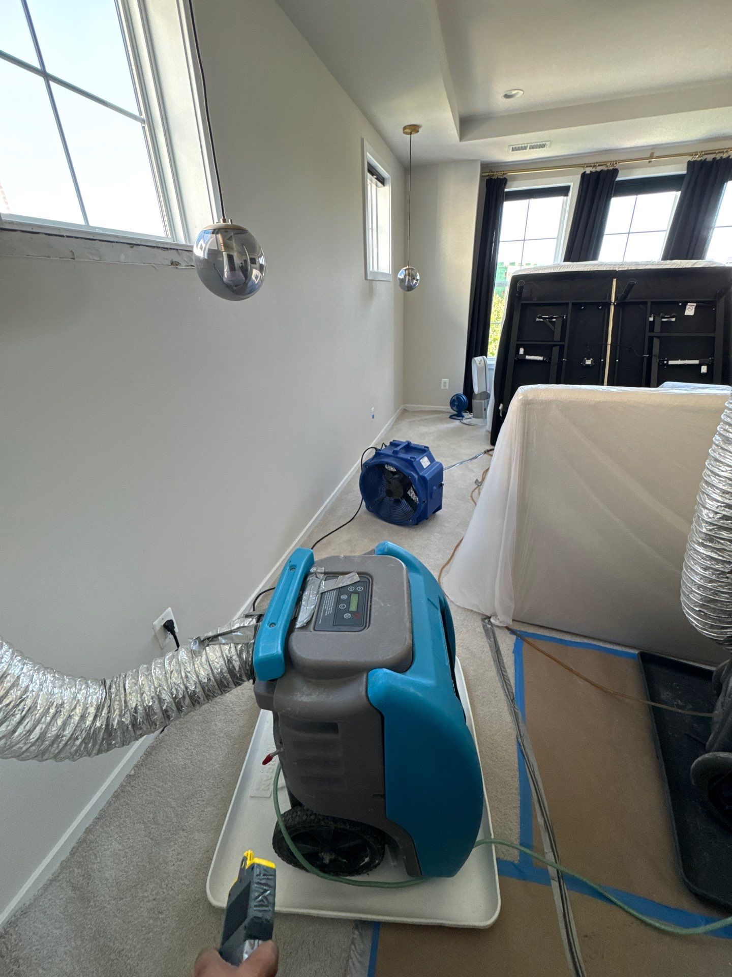 Containment barrier erected during initial water damage assessment in Ashburn, with dehumidification equipment staged.