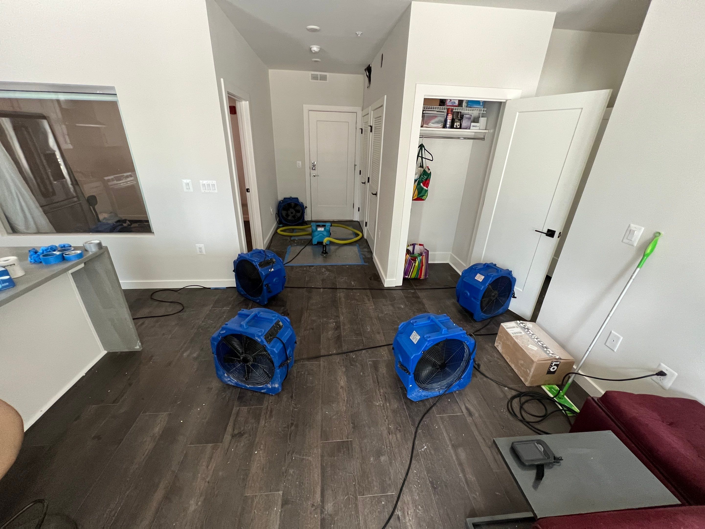 Mid-stage drying setup showing dehumidifiers and air movers working to remove moisture from affected areas.