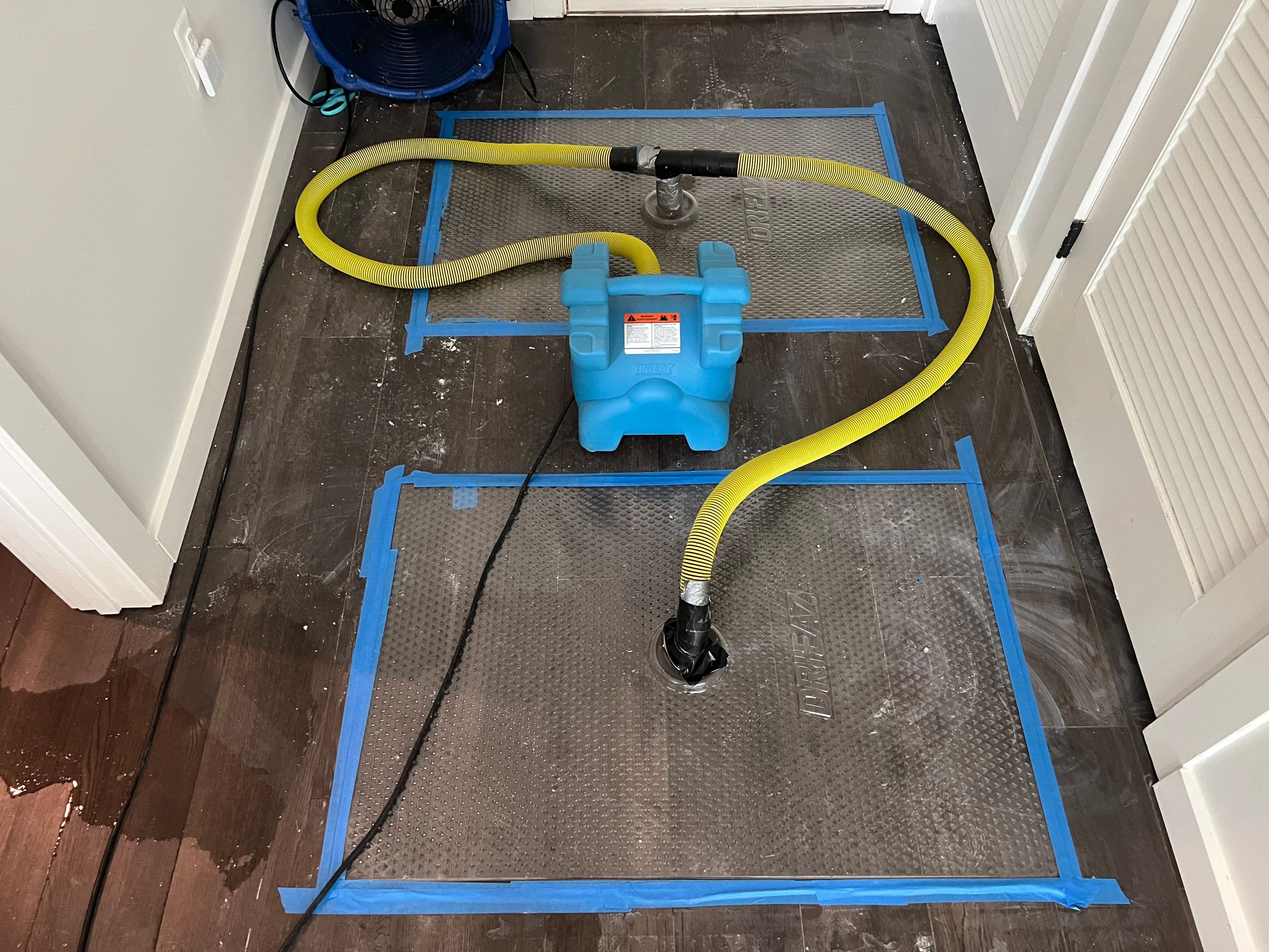 Final stages of Arlington water damage restoration with flooring remediation and equipment removal complete.