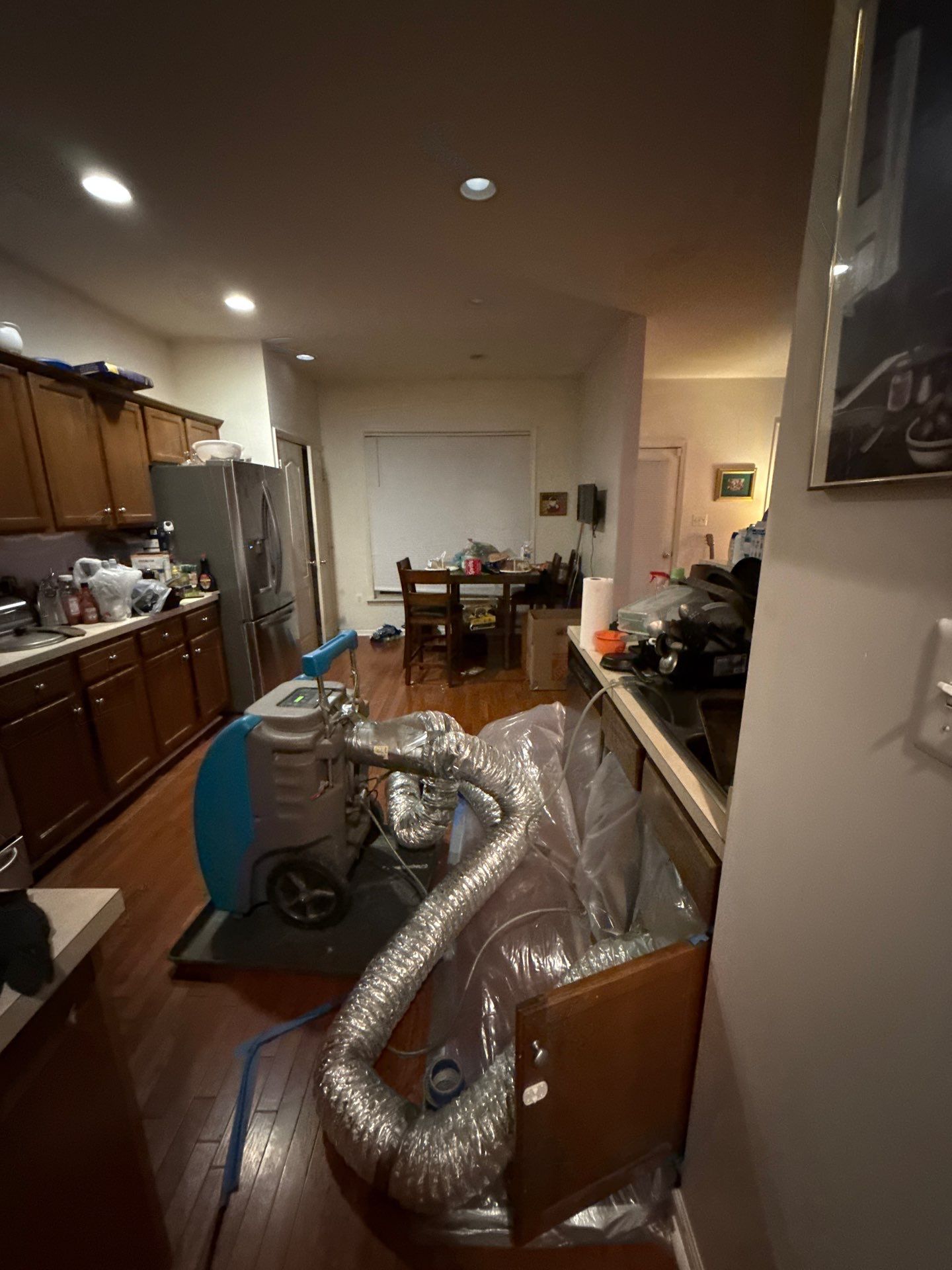 Dehumidifier and air movers positioned for structural drying after water extraction.