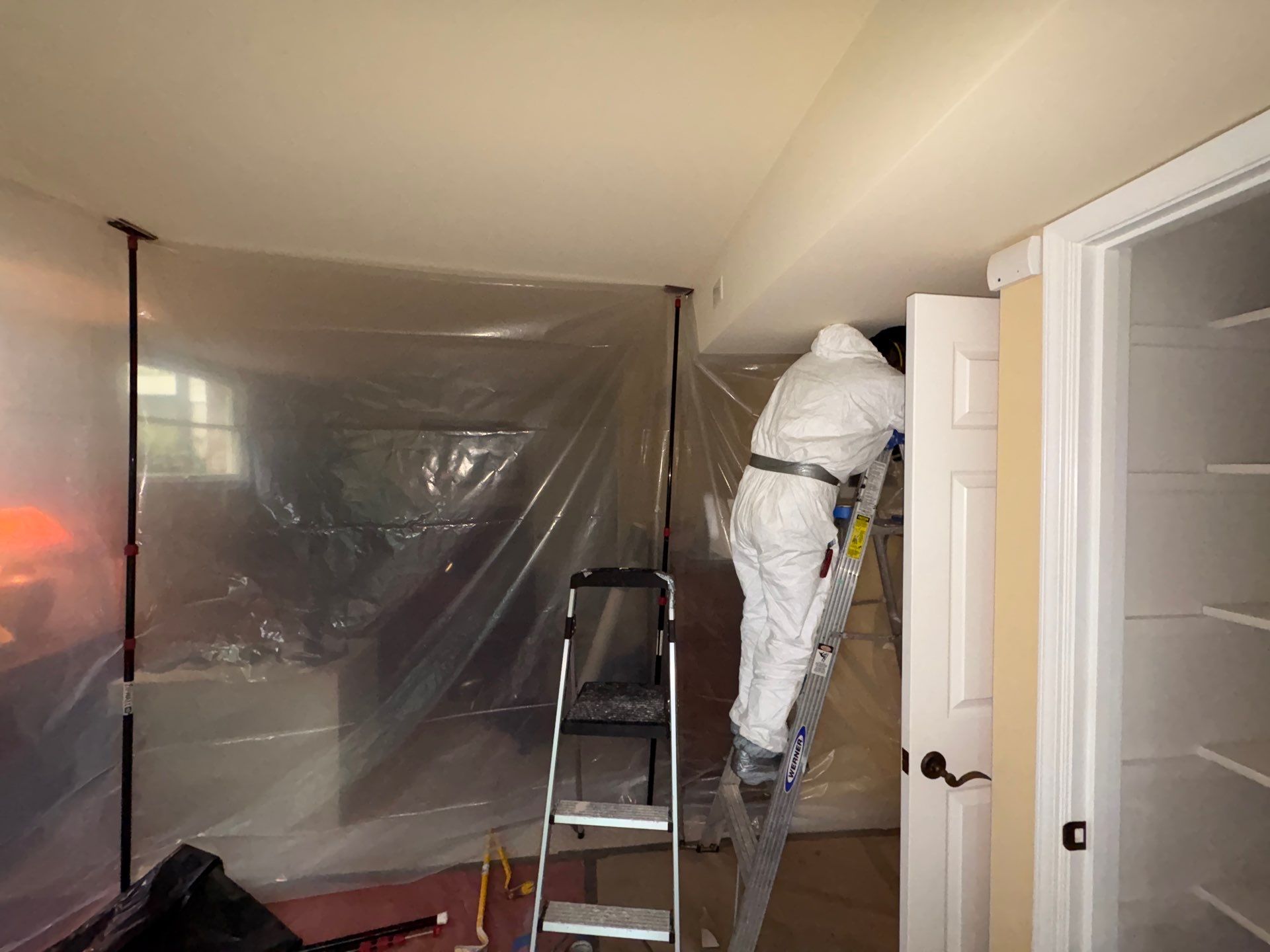 Standing water removal underway during mold remediation, extracting moisture from flooded areas in McLean home.