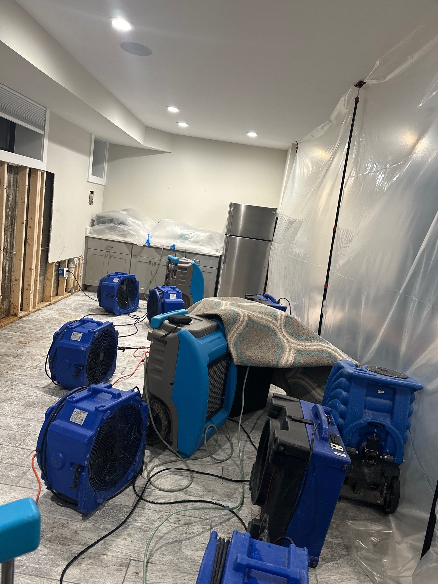 Containment barrier and dehumidification equipment set up during water damage restoration in Arlington.