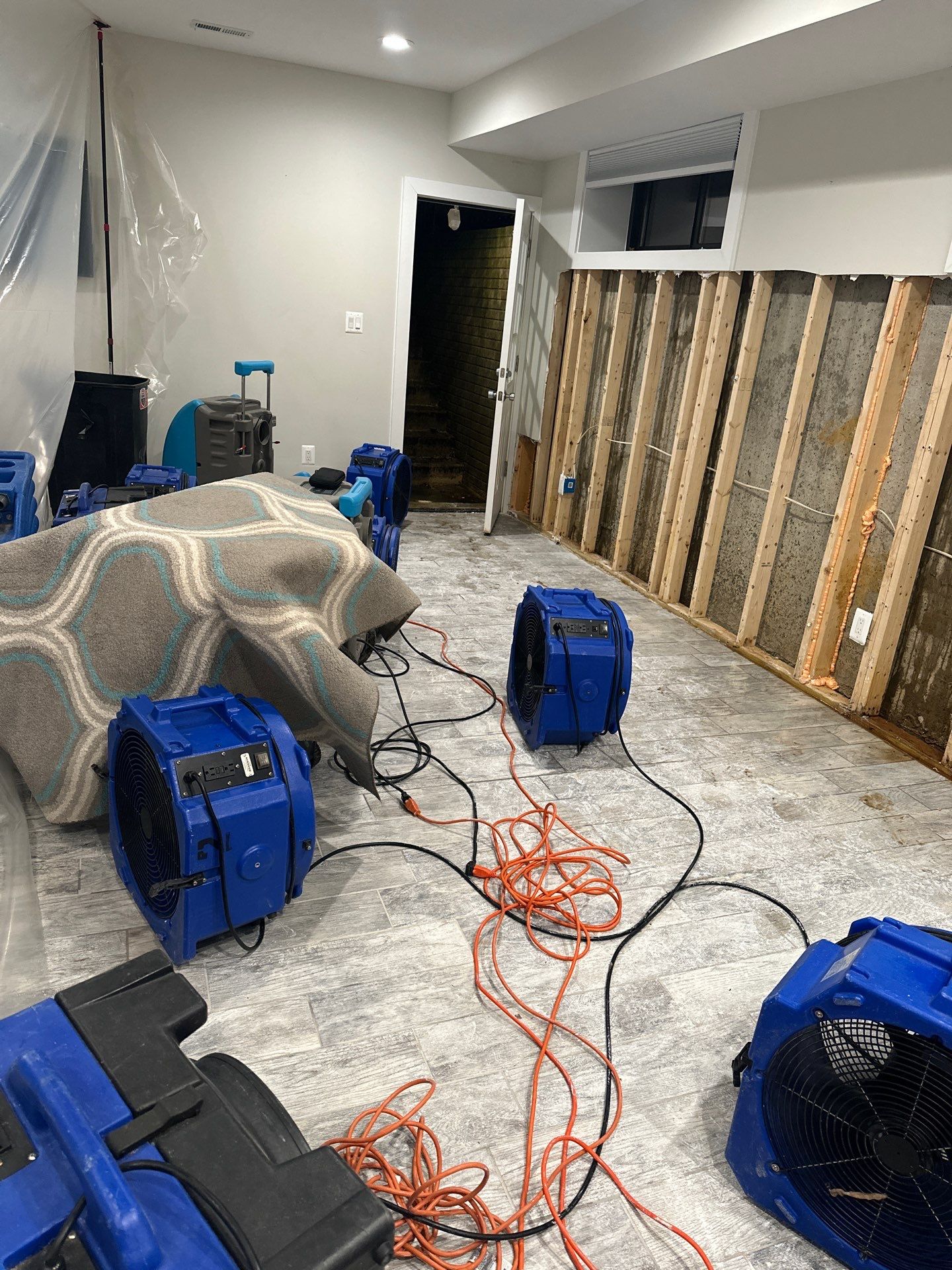 Structural drying in progress with containment and dehumidifiers managing moisture removal.