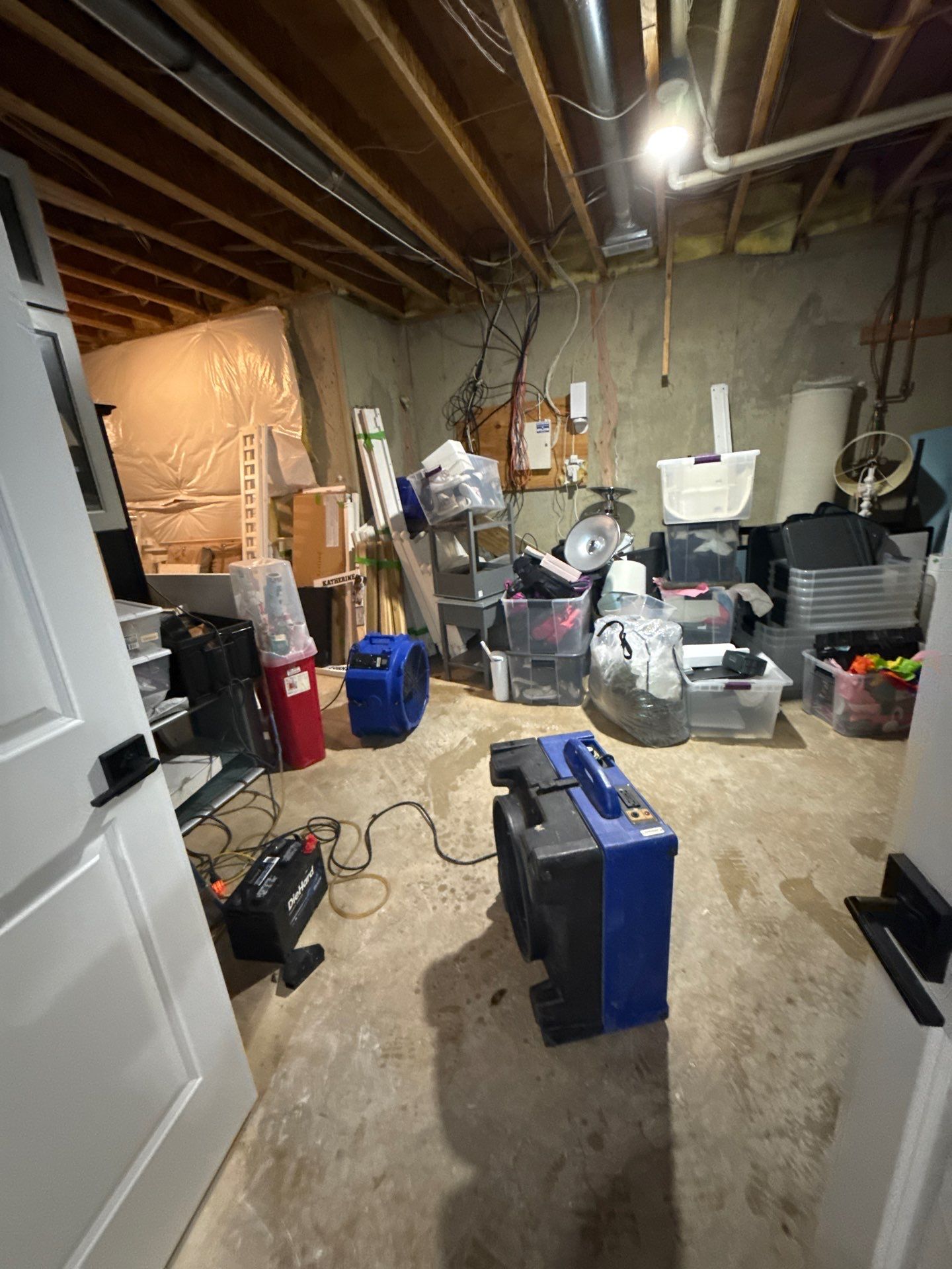 Structural components dry while baseboard replacement materials stage for final finishing work.