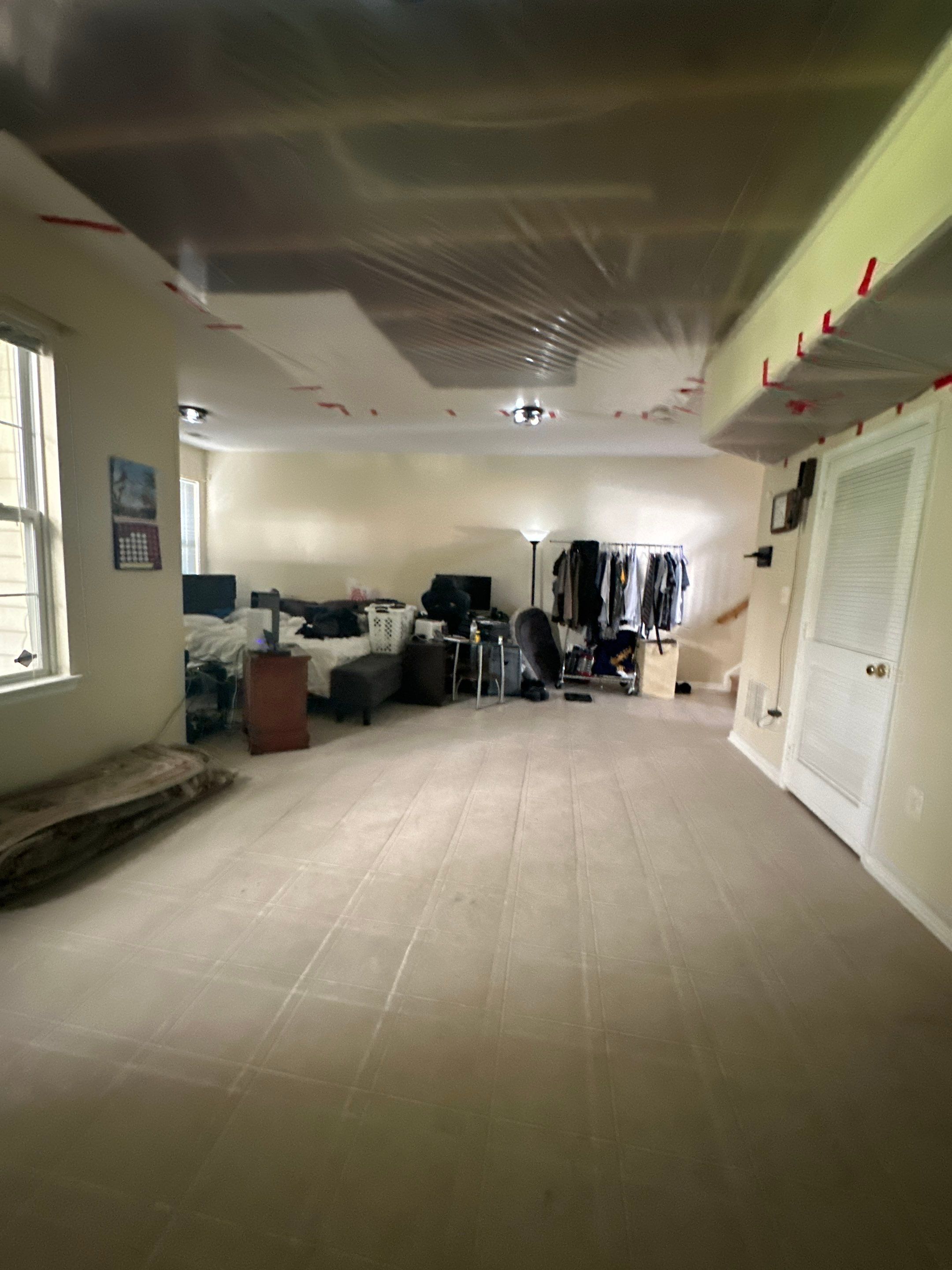 Mid-stage water damage restoration showing continued dehumidification and monitoring of drying progress.