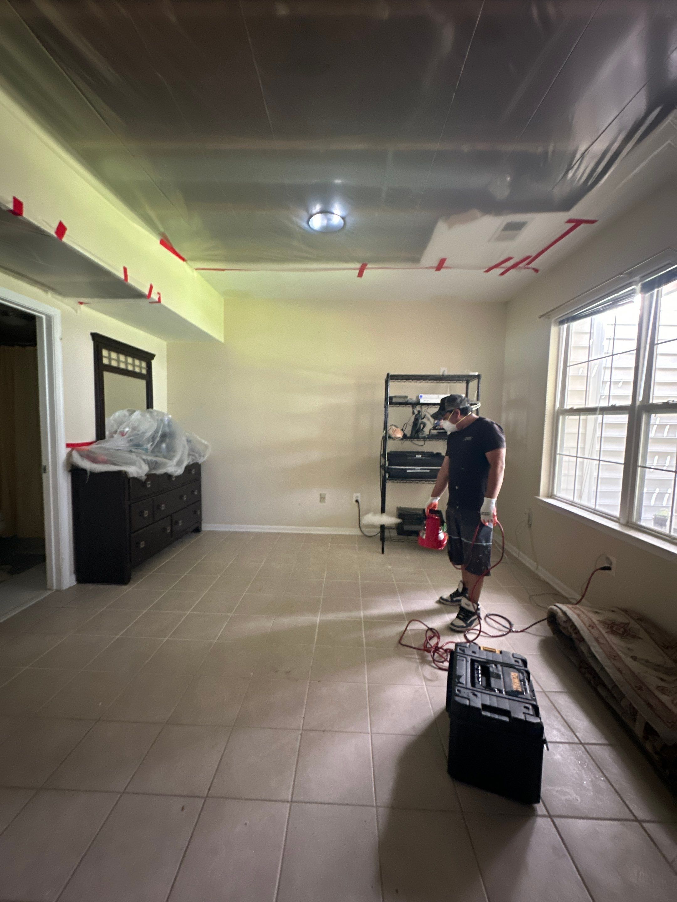 Final-stage water damage restoration in Ashburn with ceiling repair completed and equipment removal underway.
