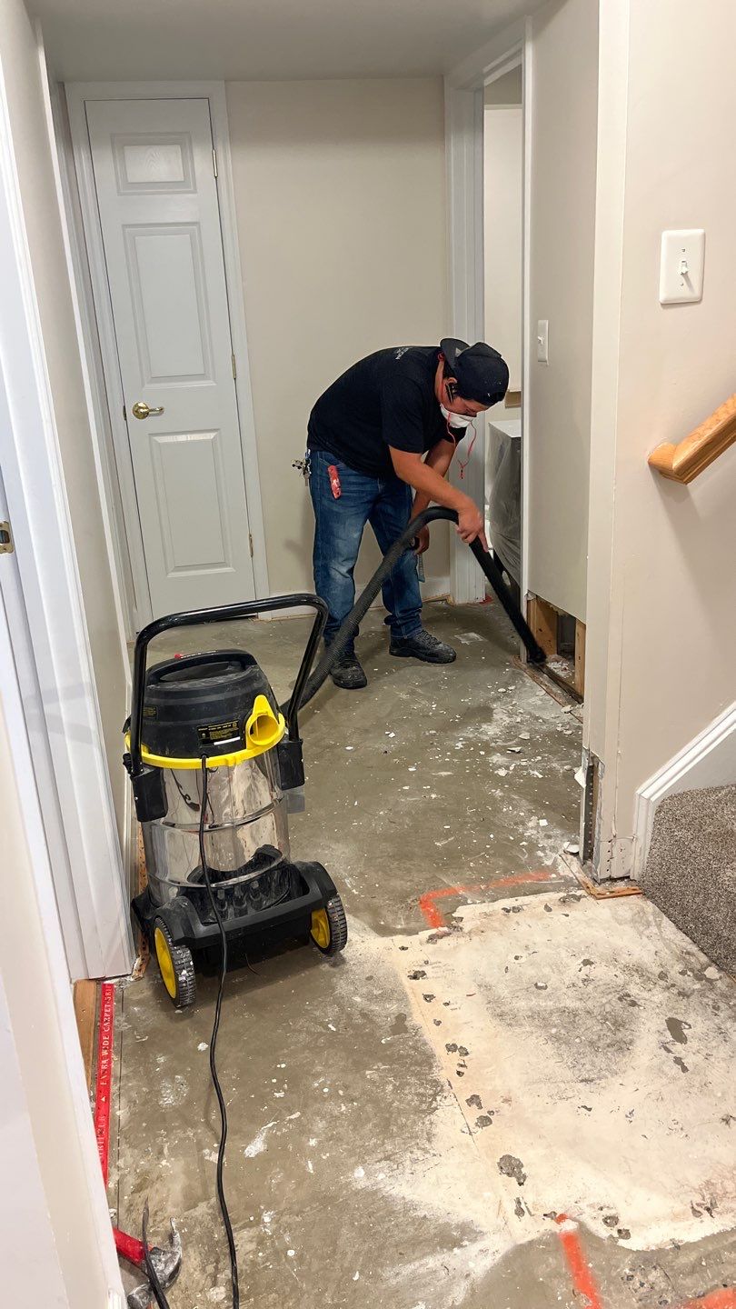 Mid-stage drying operation showing moisture removal equipment and flooring preparation for remediation.