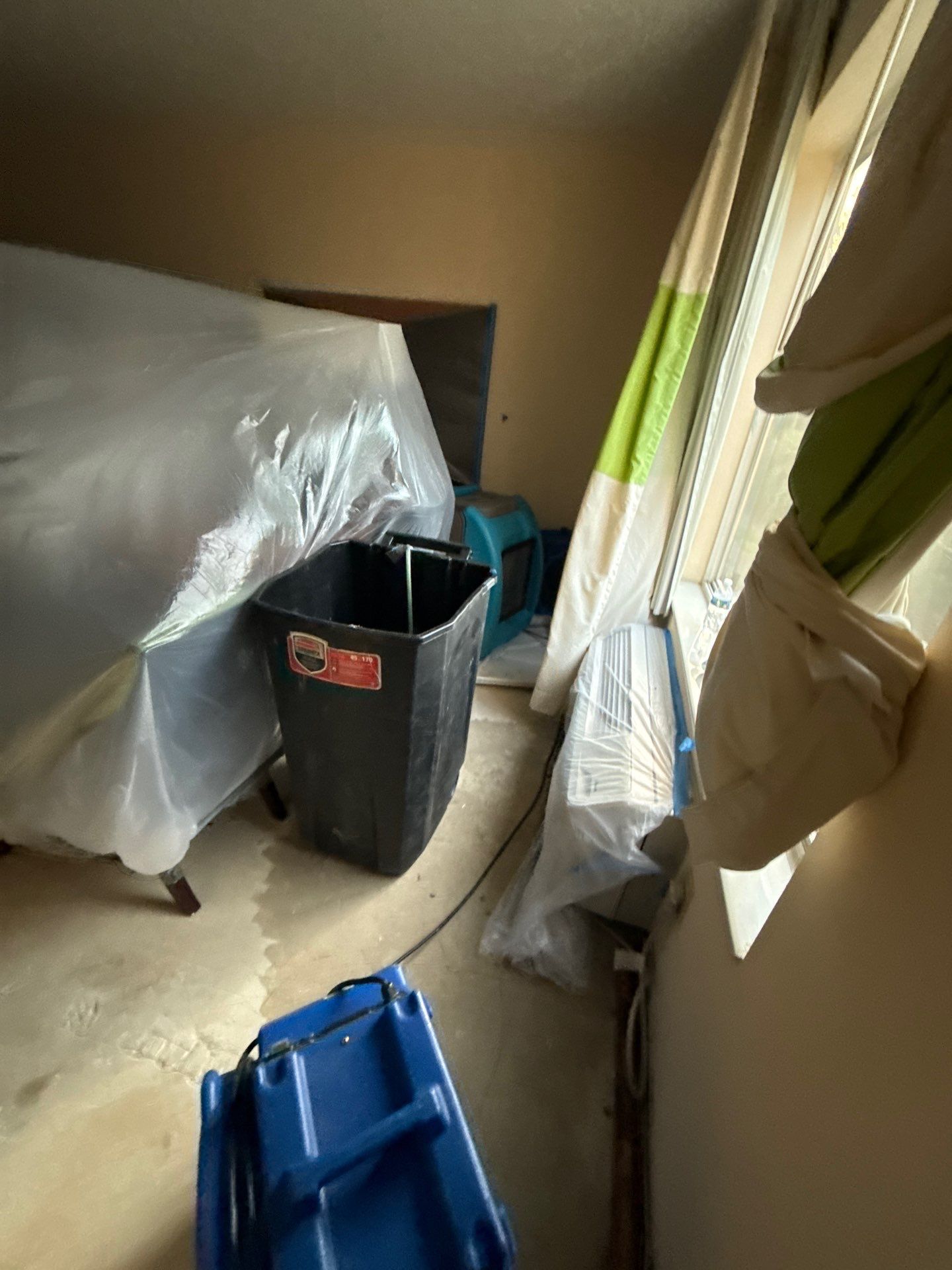 Structural materials in mid-drying phase, moisture removal in progress for Manassas water restoration.