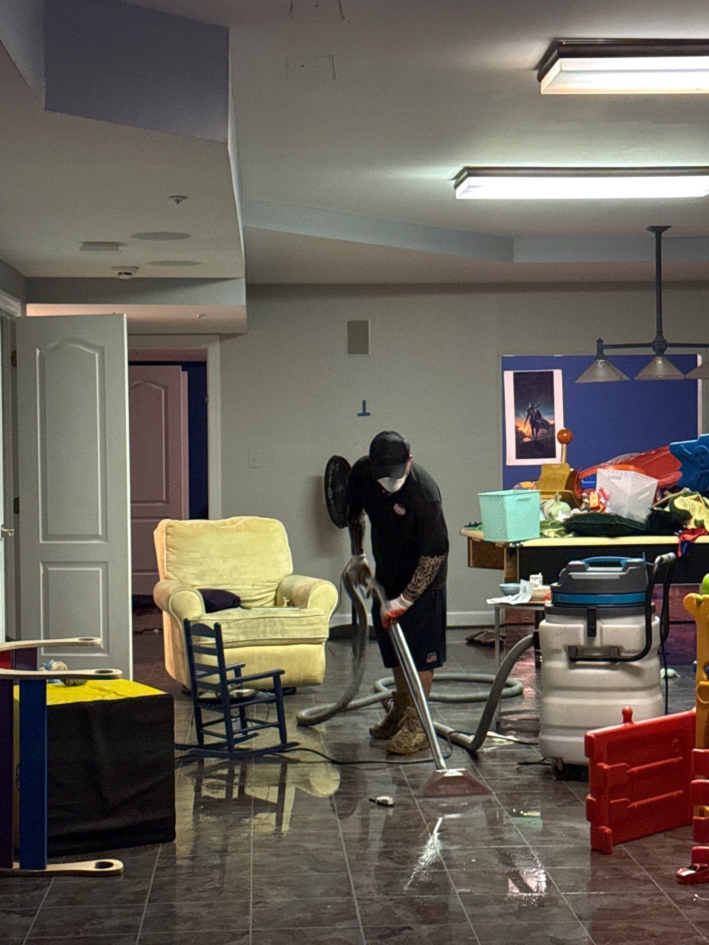 Structural drying in progress with dehumidifiers and air movers deployed throughout the space.
