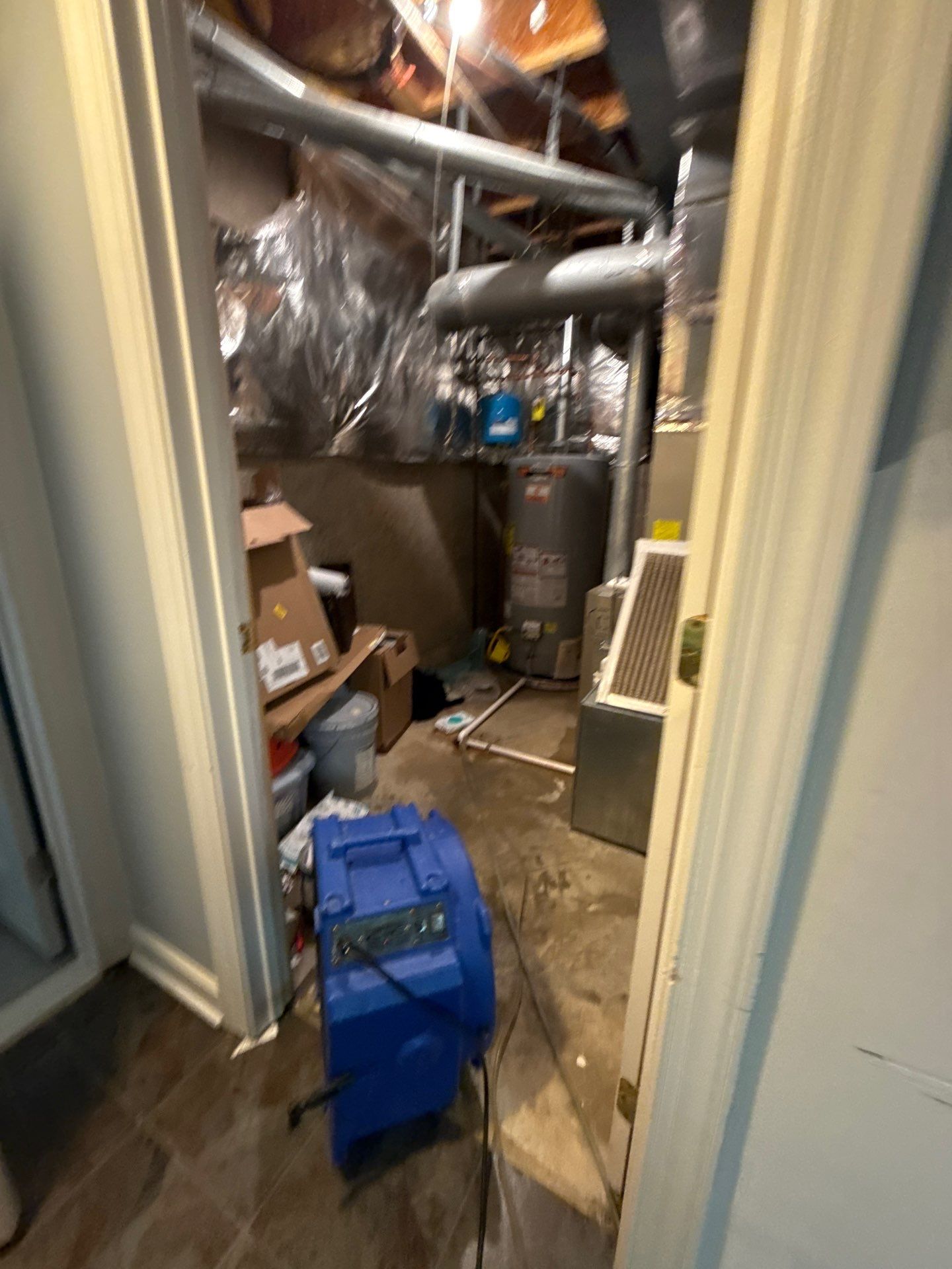 Continued drying phase with equipment monitoring moisture levels in structural materials.