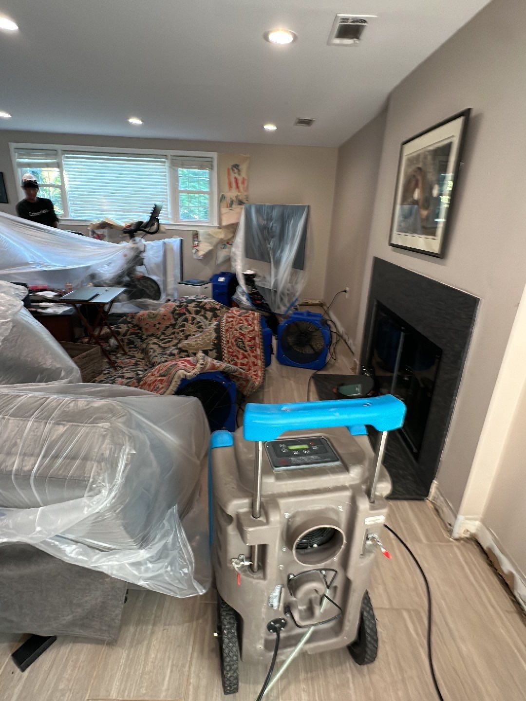 Dehumidification equipment positioned for structural drying during moisture remediation.
