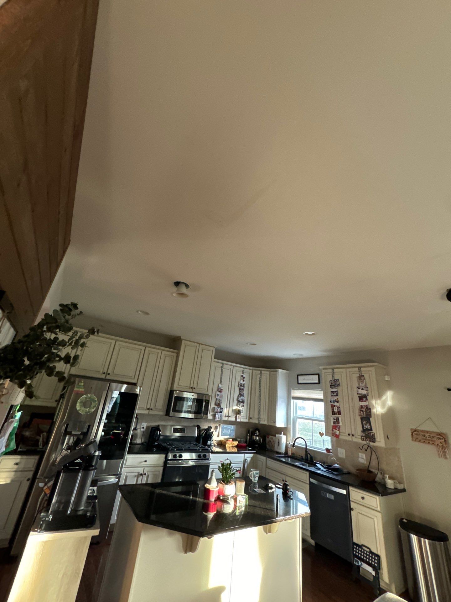 Repaired ceiling reinstalled after water extraction, drying, and structural restoration work completed.