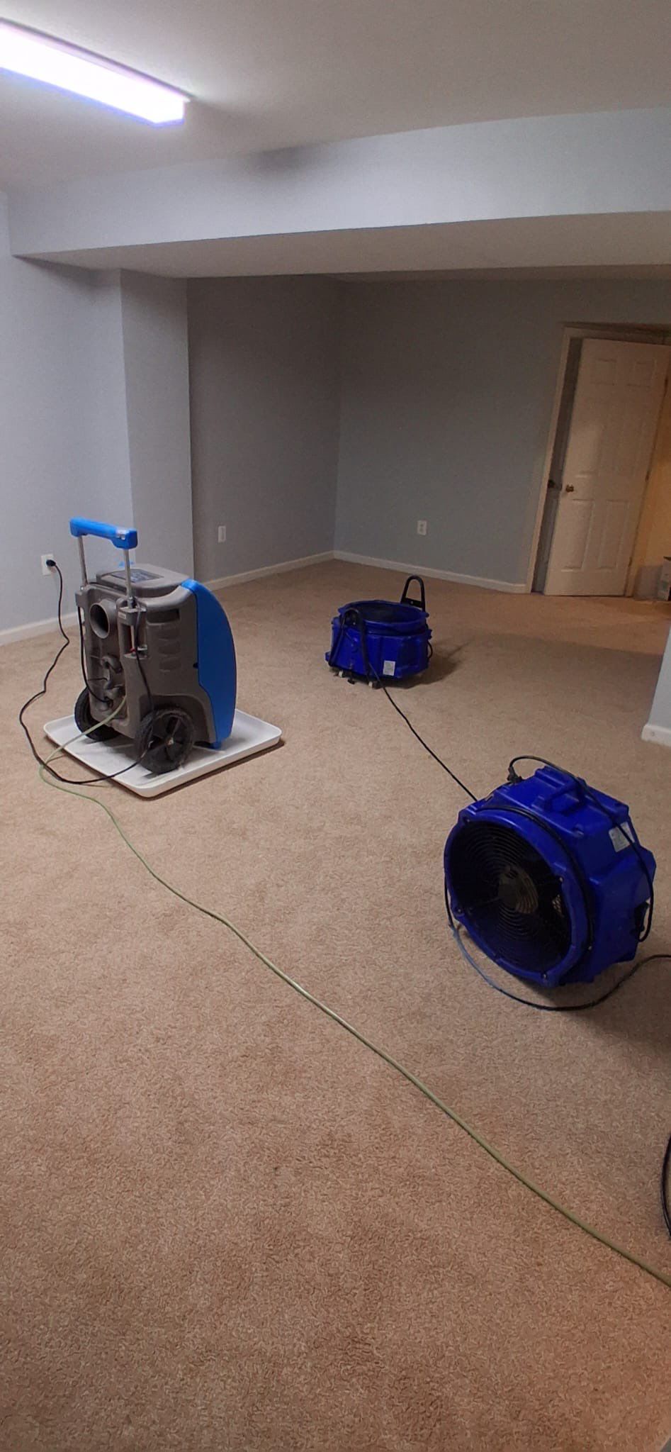 Sanitizing application in progress on structural surfaces within containment barrier.