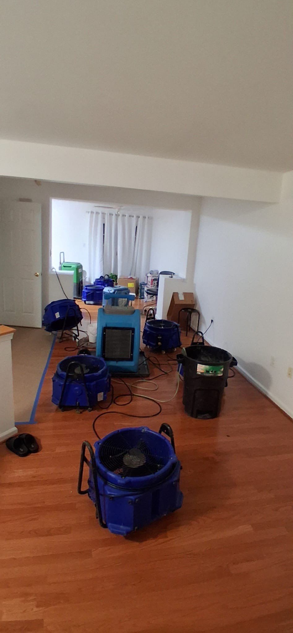 Negative air unit and dehumidifier operating to manage moisture during remediation.
