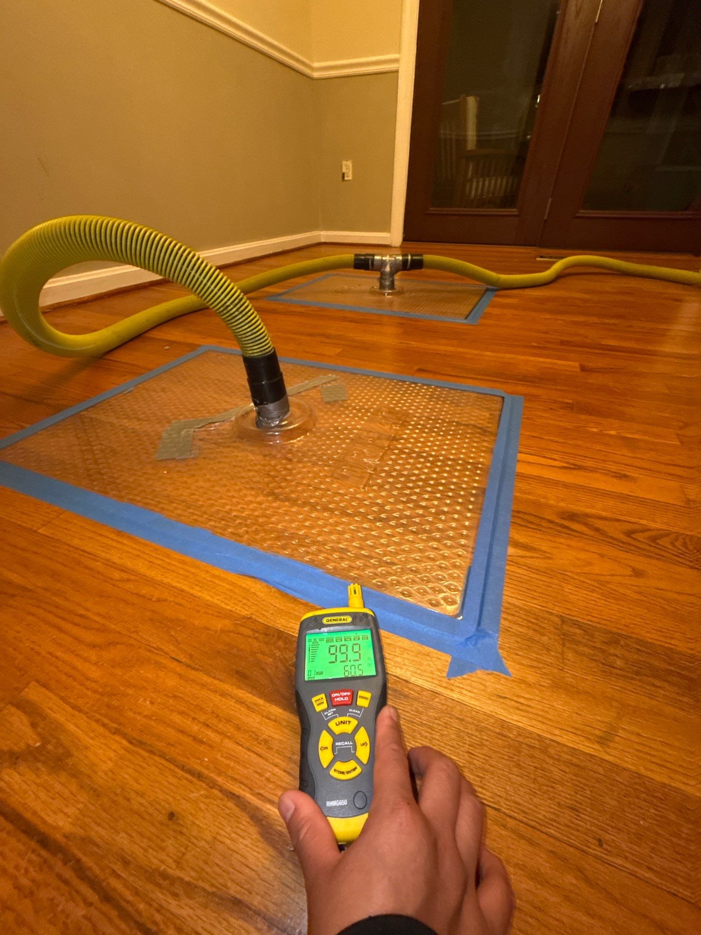 Continued structural drying with dehumidifiers and air movement equipment operating during water damage mitigation.