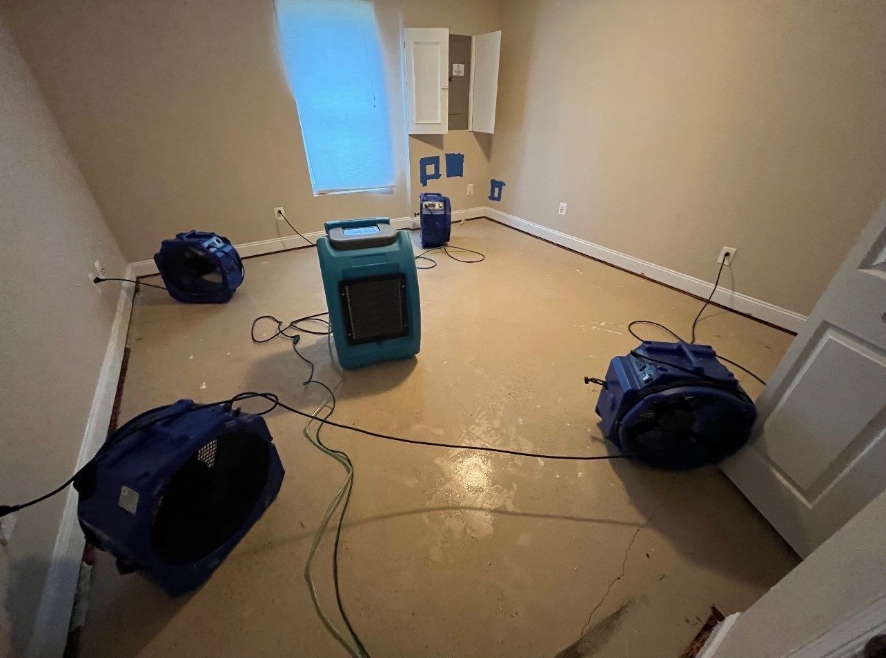 Dehumidification and air movement equipment continuing structural drying within containment.