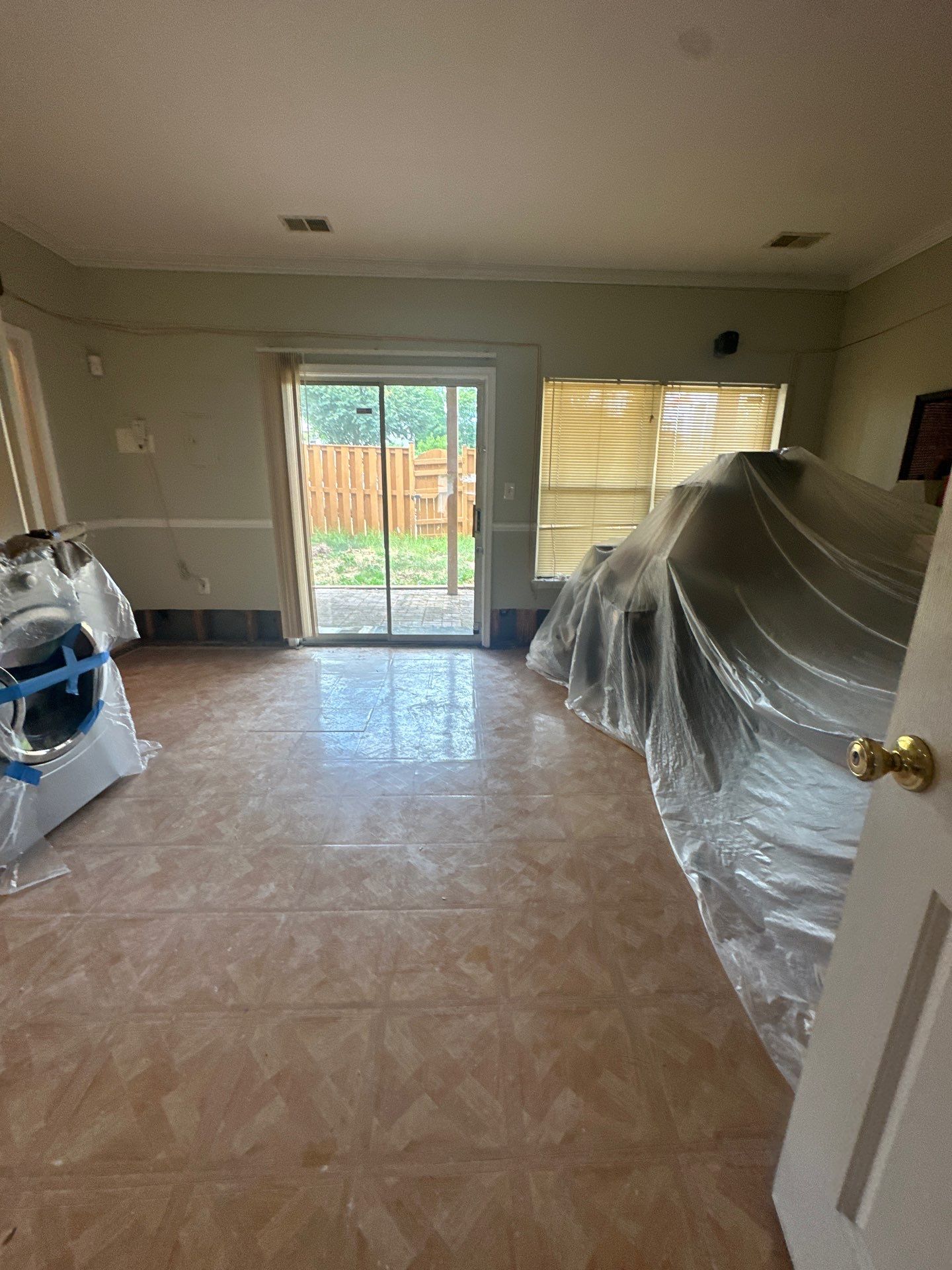 Drying equipment monitoring moisture levels in wall cavities and subfloor during restoration.