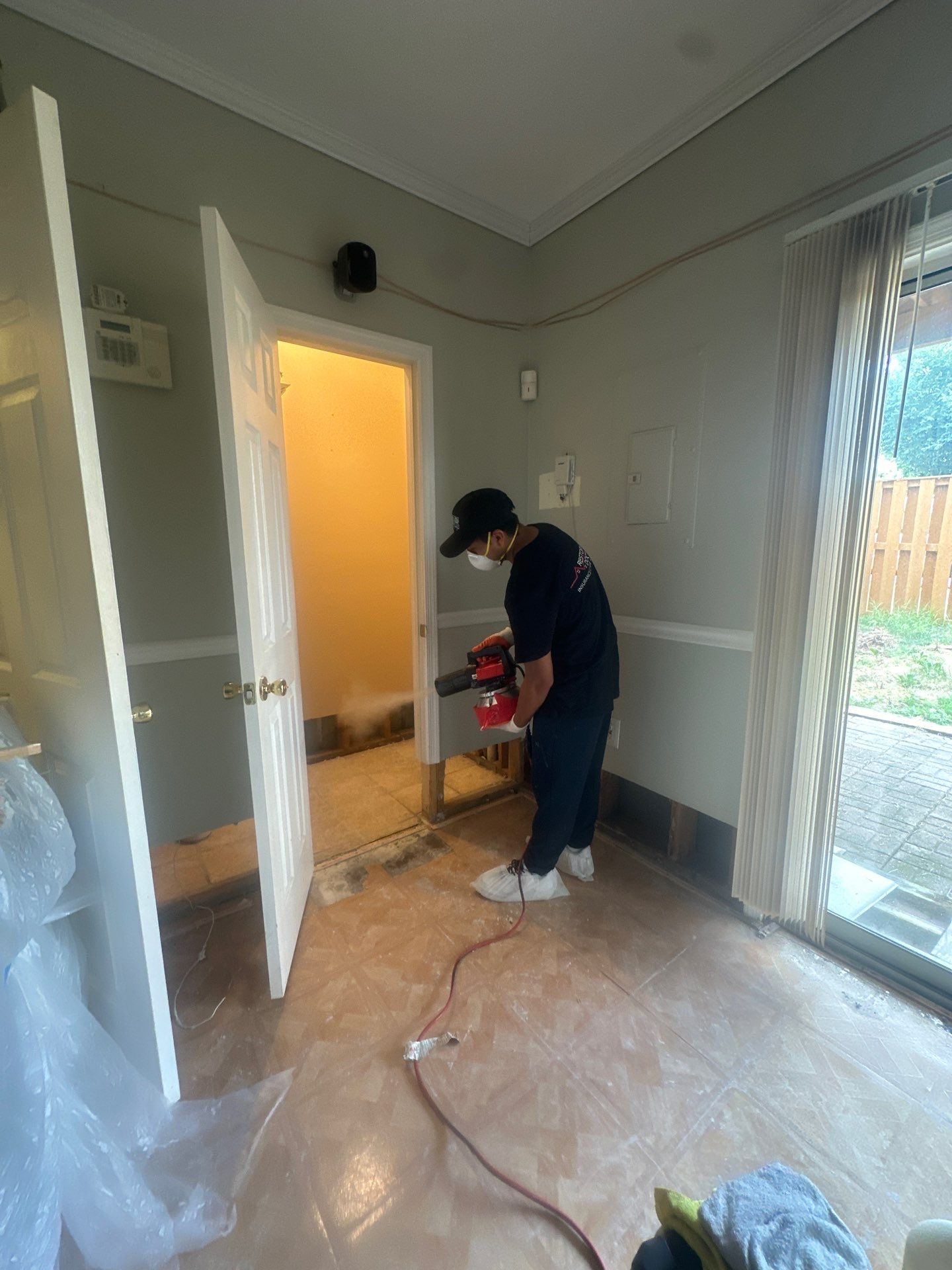 Removed baseboards and saturated materials staged for disposal in water restoration process.