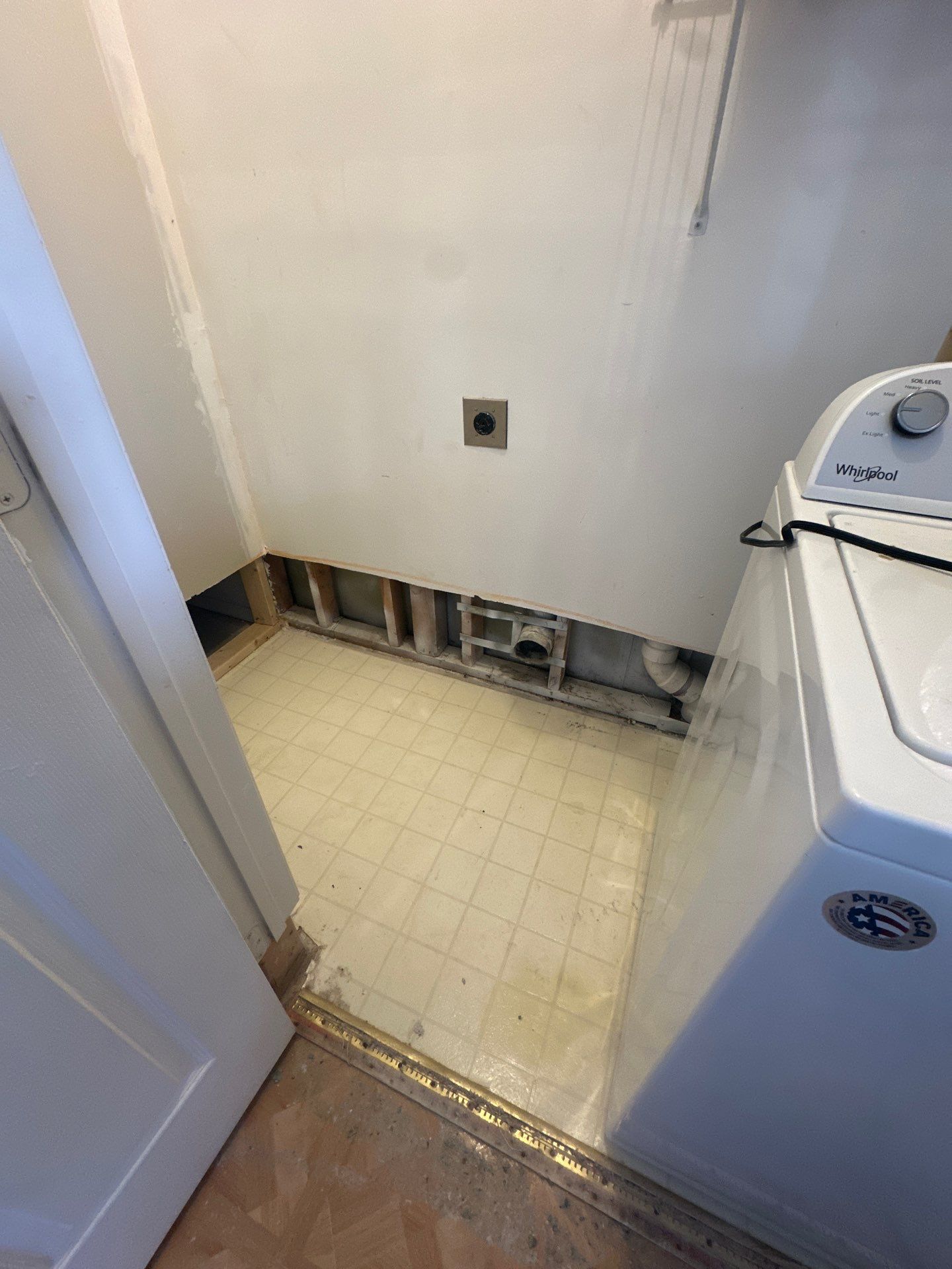 Dehumidifier and air movers positioned for structural drying during water damage mitigation.