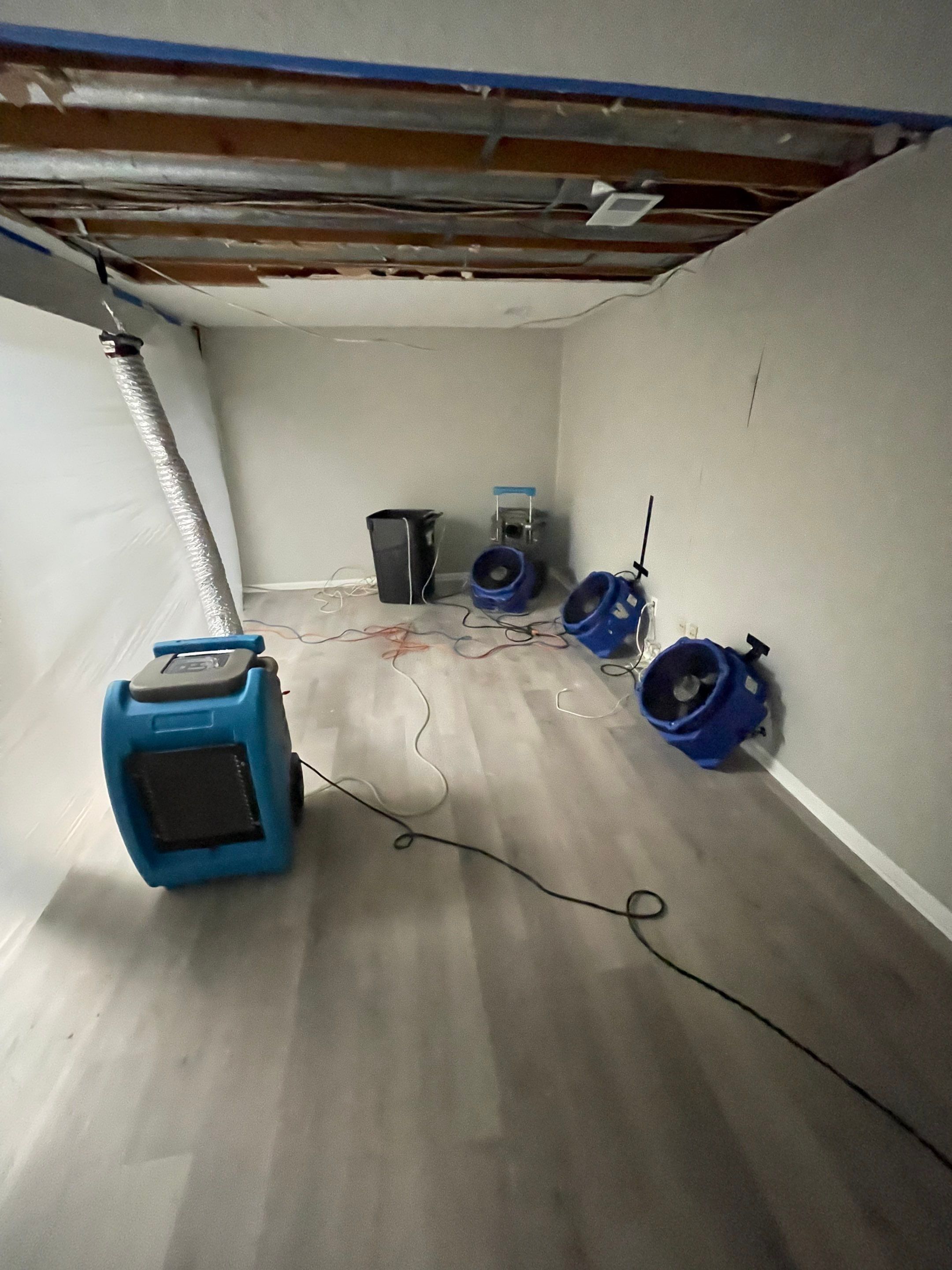 Dehumidification equipment positioned for structural drying during moisture remediation.