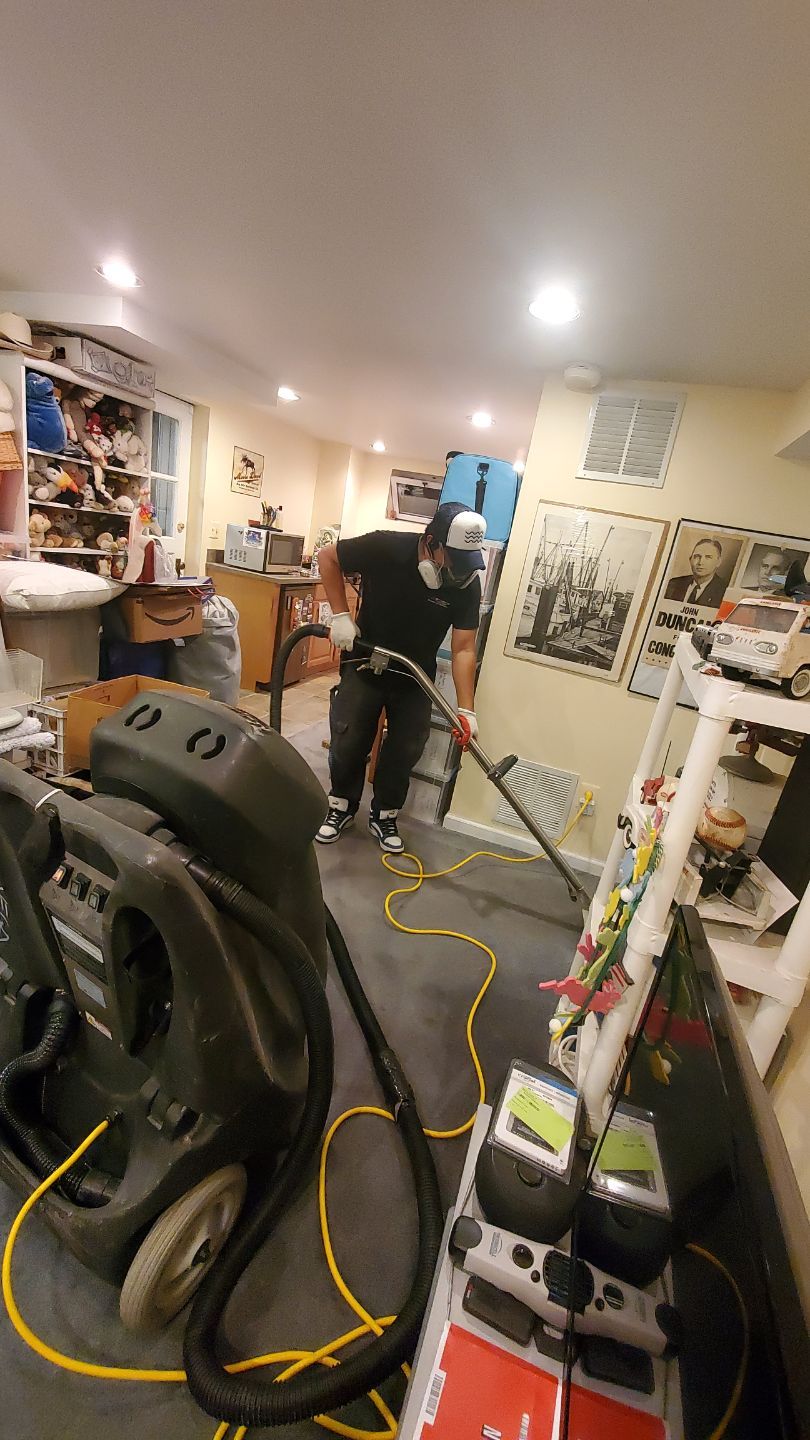 Standing water extraction underway in Falls Church water damage restoration, initial assessment phase.