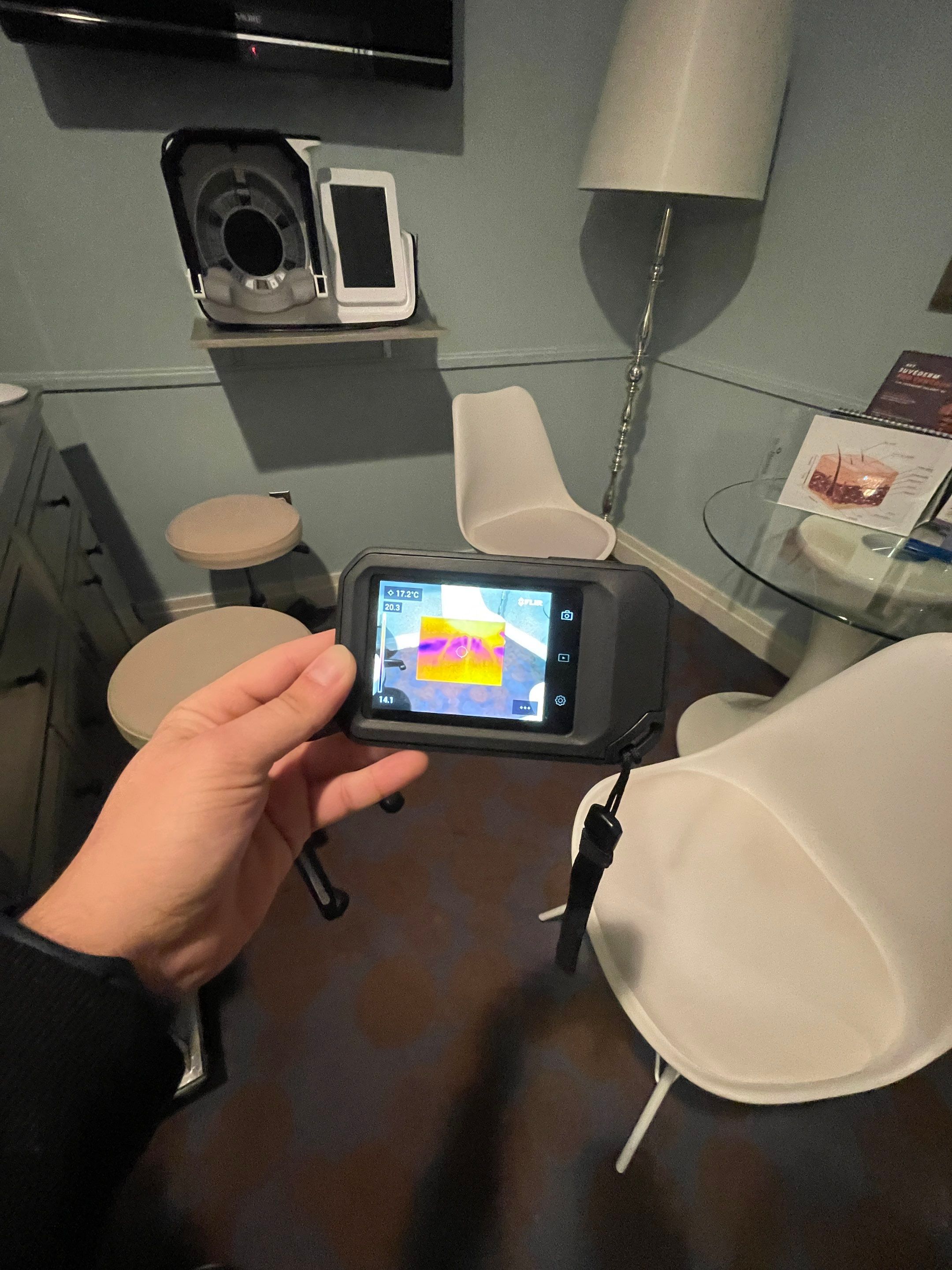 Thermal imaging moisture inspection revealing hidden water saturation within wall cavity during restoration.