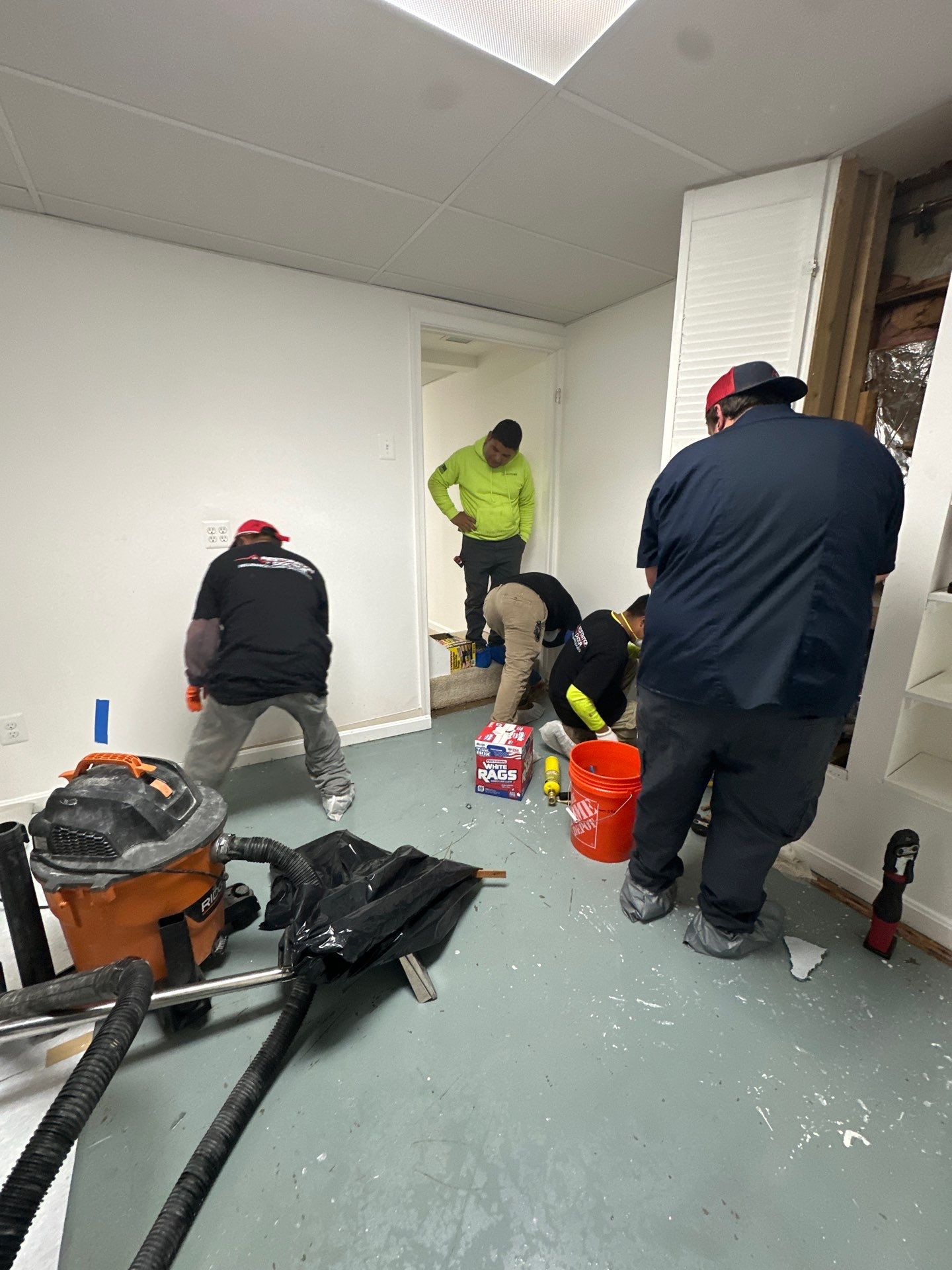 Structural drying equipment positioned throughout affected room during restoration work.