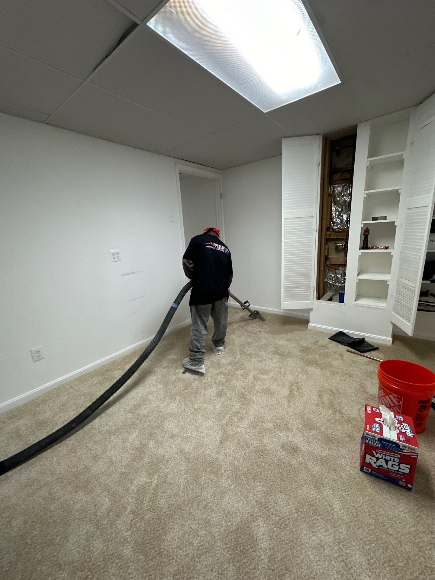 Dehumidifiers and air movers operating to dry structural materials after water extraction.