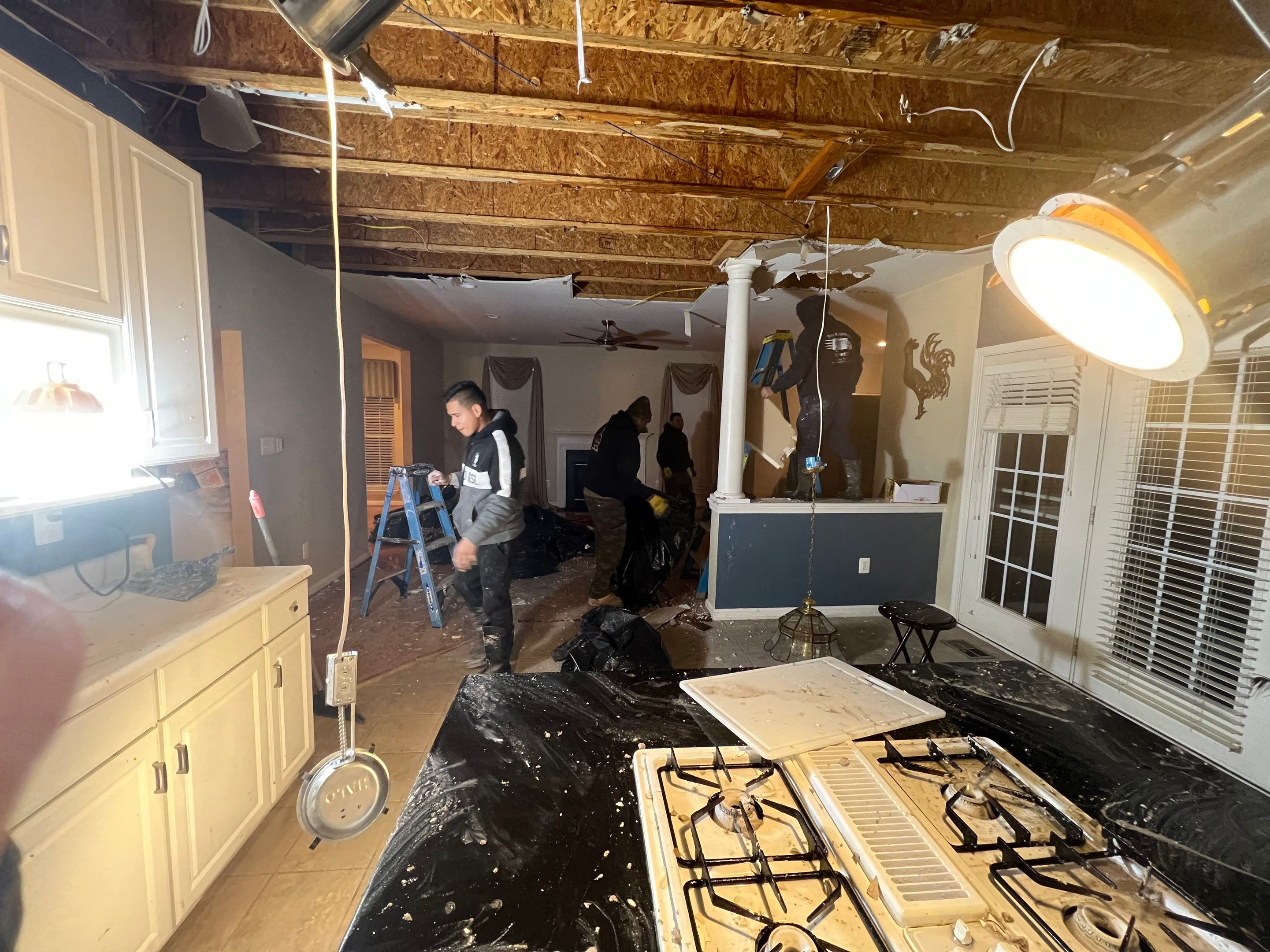 Standing water extraction underway in Ashburn water damage restoration, wet flooring visible.