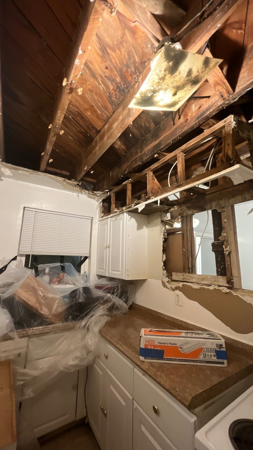Wet carpet and flooring being removed as part of water damage remediation.