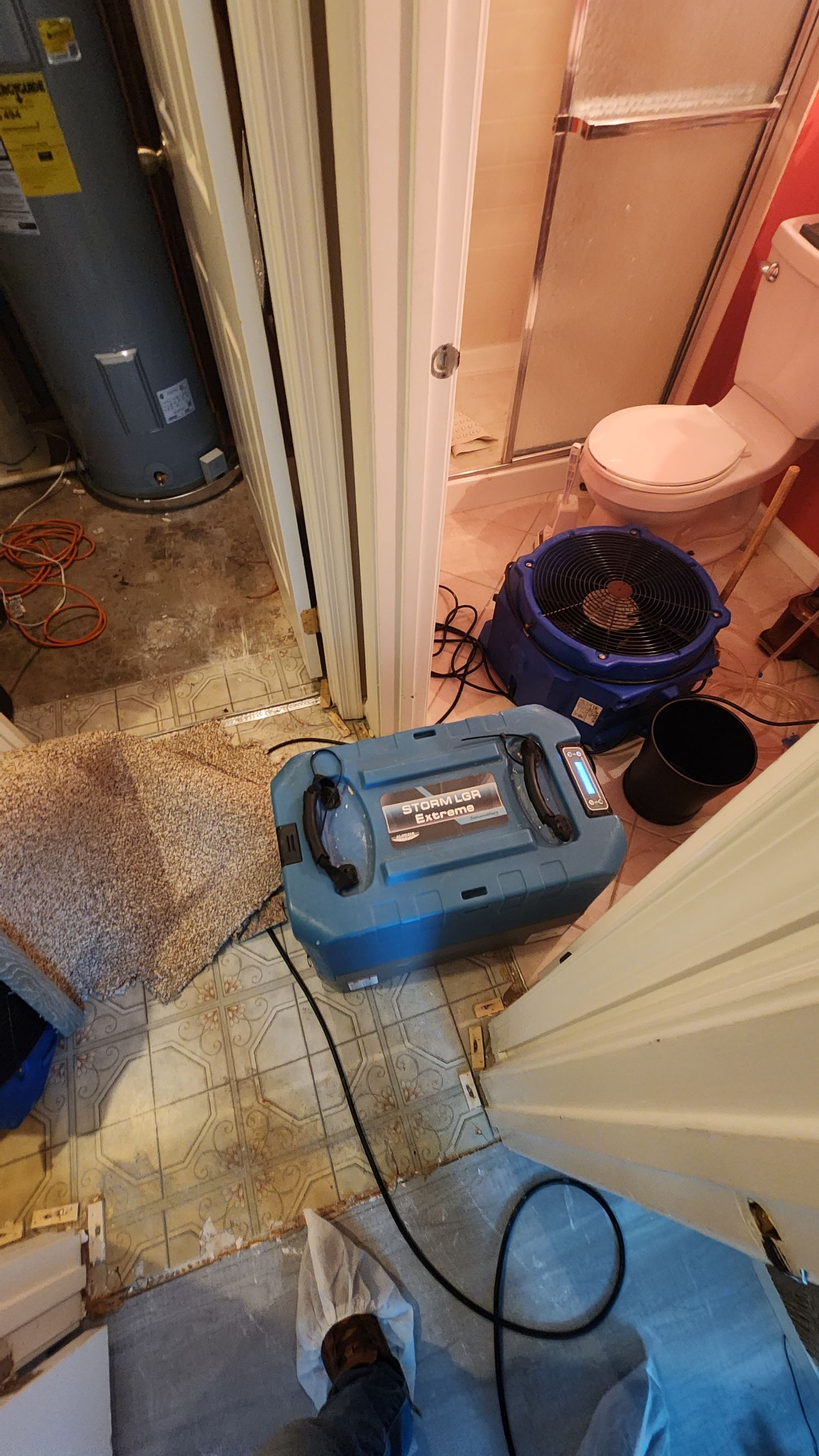 Dehumidification equipment positioned for structural drying during moisture remediation.