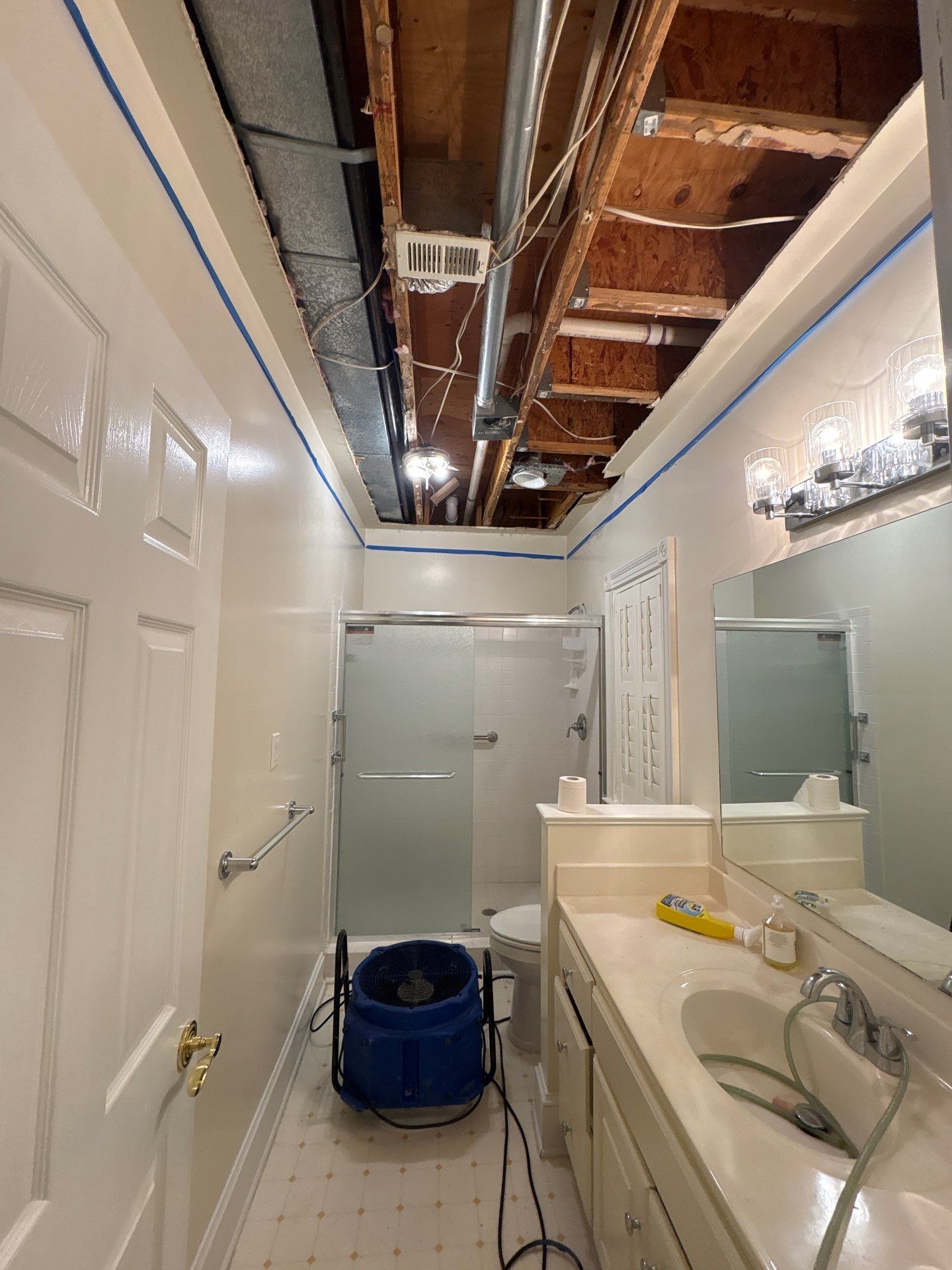 Wet drywall and framing exposed during water damage assessment and removal in McLean restoration work.