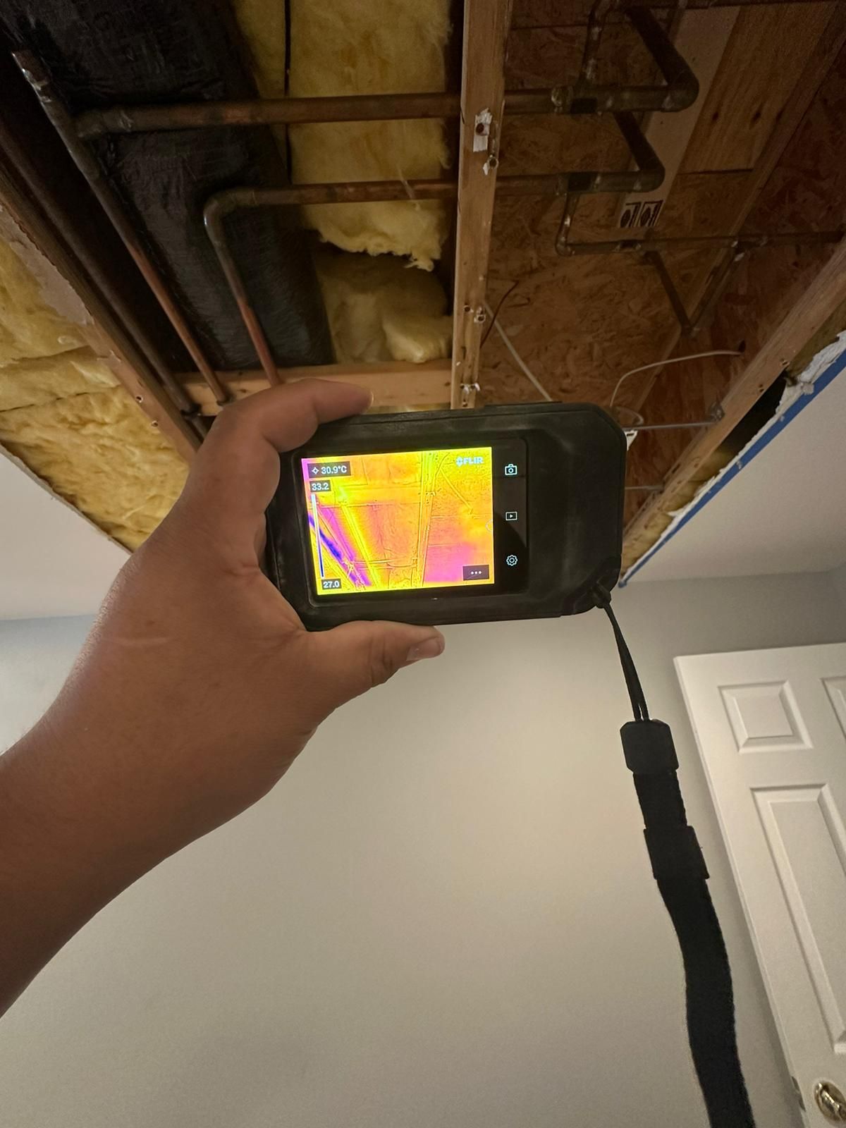 Dehumidification unit operating within containment during moisture mapping phase of water restoration work.