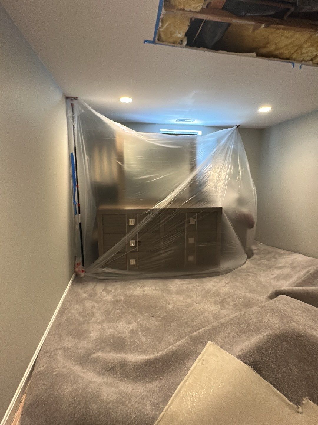 Containment barrier and dehumidifier in place as restoration progresses through mid-sequence drying phase.