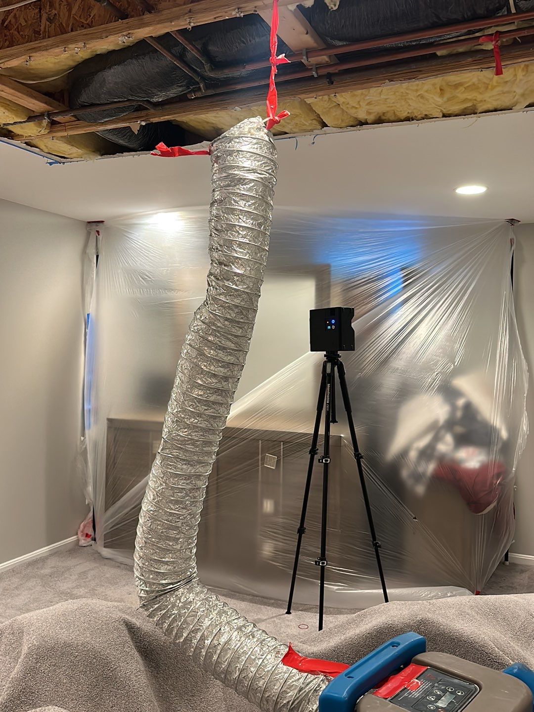 Containment barrier erected during water damage restoration in Broadlands, with thermal imaging equipment positioned for moisture inspection.