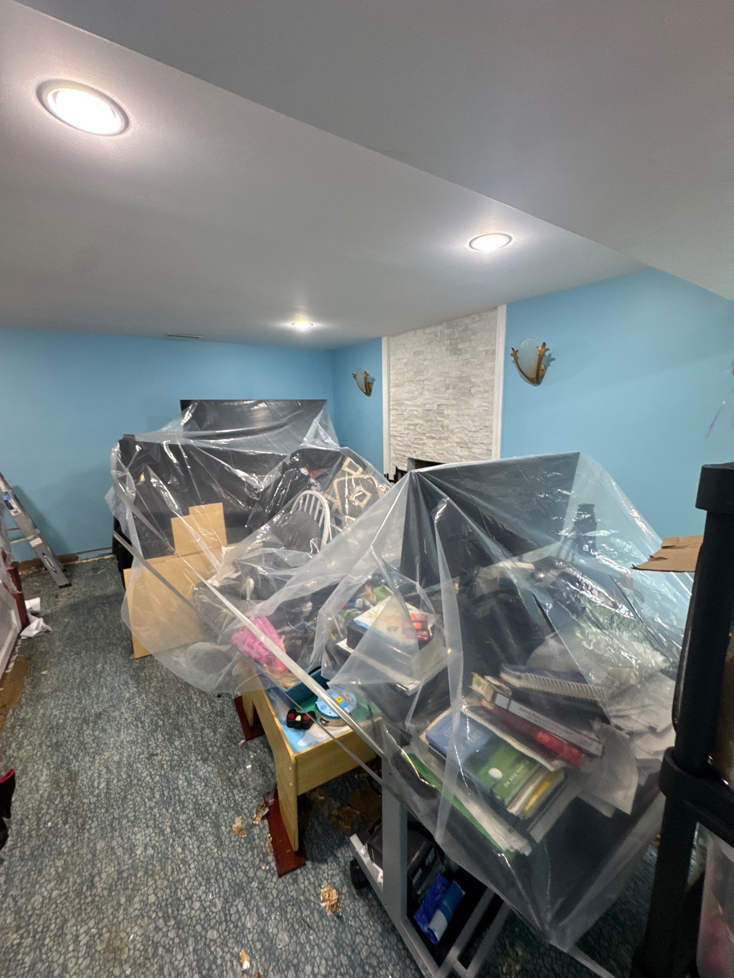 Flooring removal and disposal in progress, with containment barriers isolating the work area from unaffected spaces.