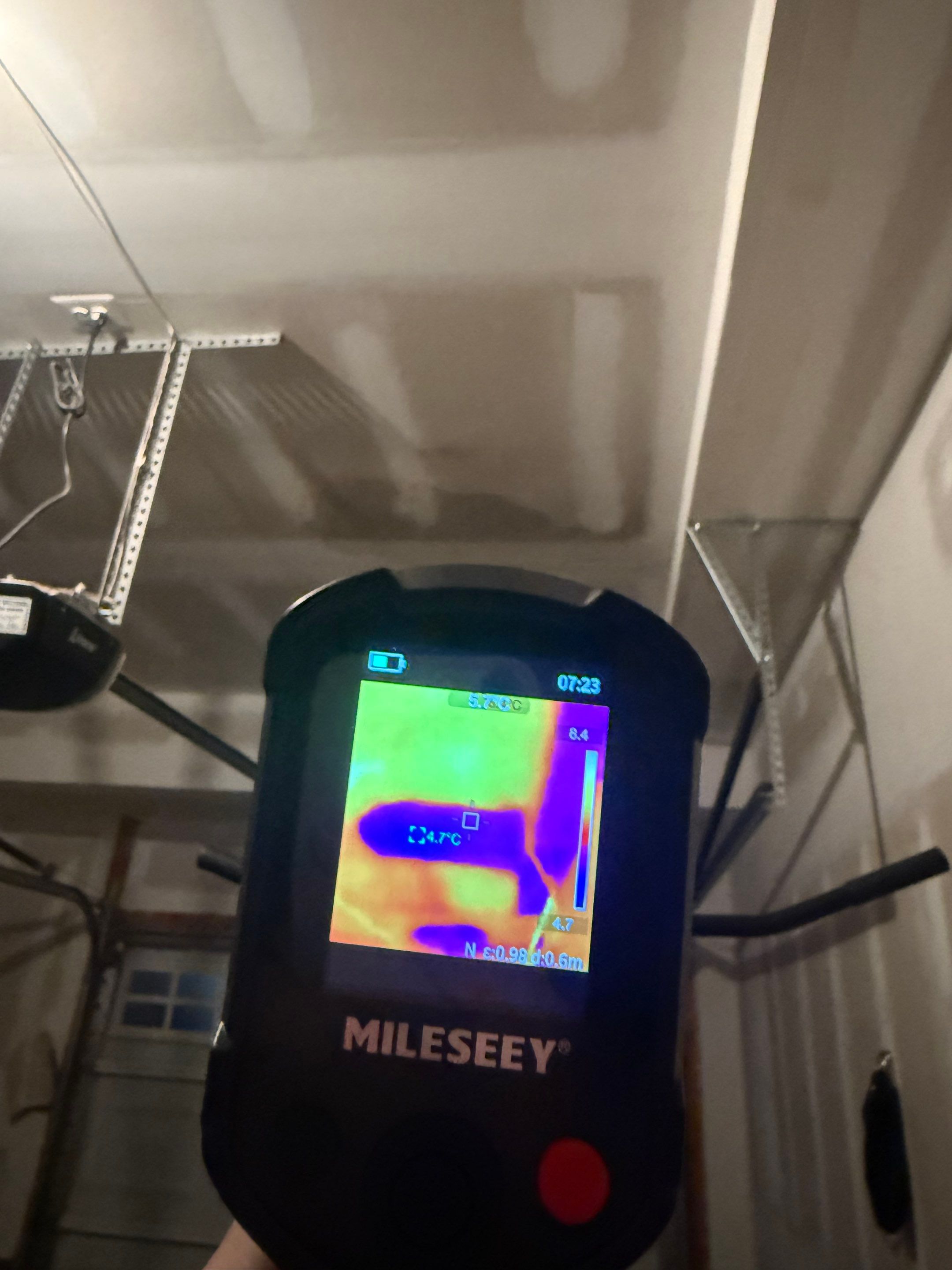 Thermal imaging camera detecting moisture patterns during water damage inspection in Ashburn.