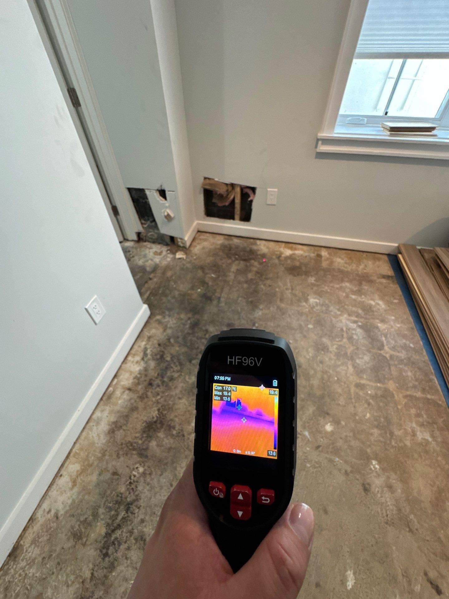 Thermal imaging camera documenting moisture patterns in Arlington water damage restoration, initial assessment phase.