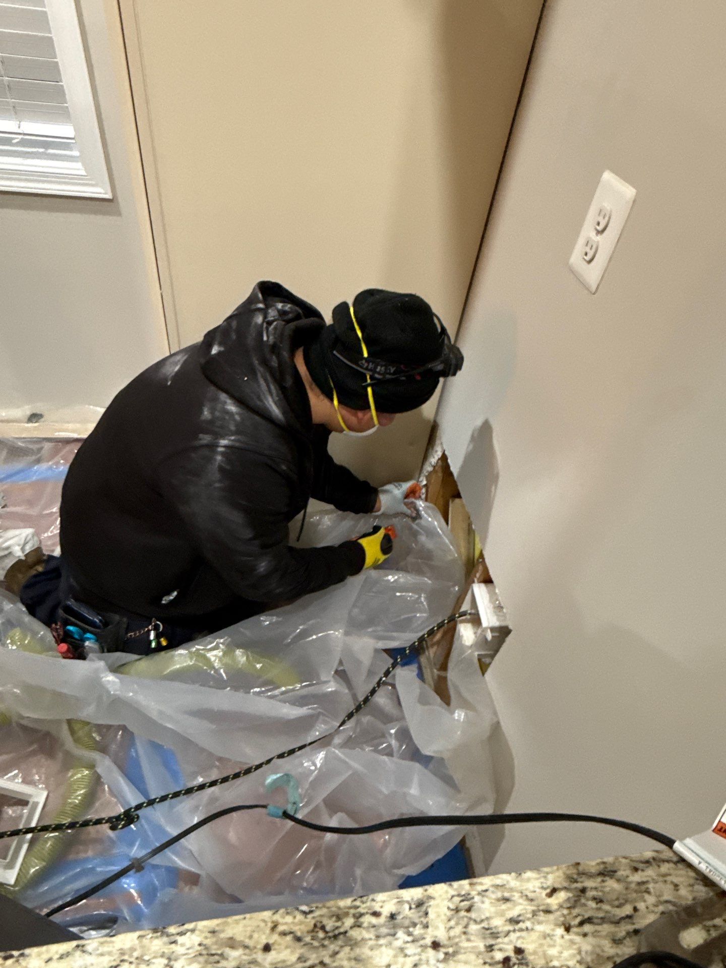 Mid-stage drying setup showing dehumidifiers and air movers working to reduce moisture levels in the remediation zone.
