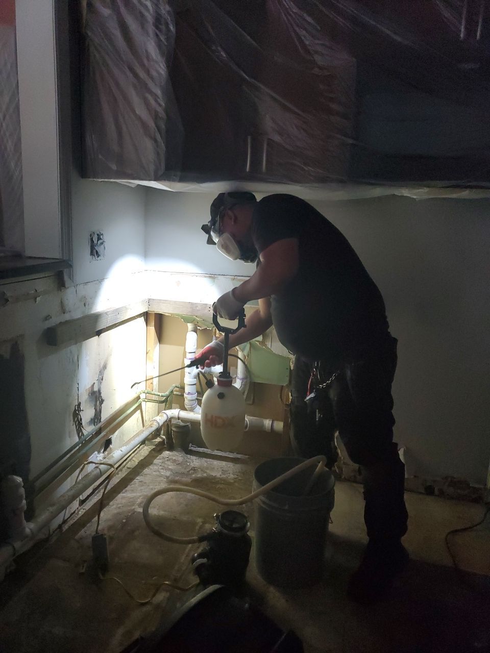Technician operates extraction equipment to remove standing water from affected flooring during Sterling restoration.