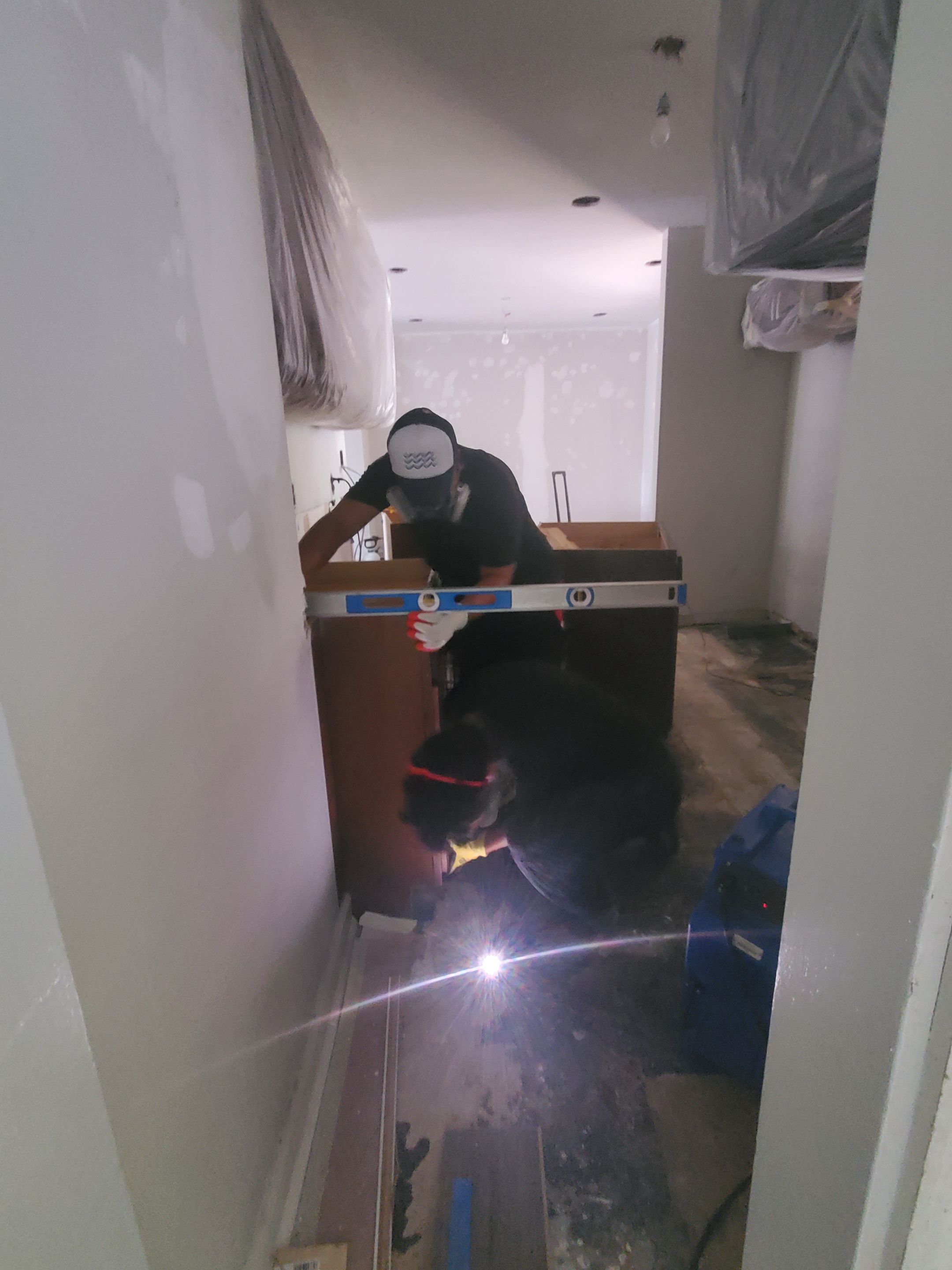 Standing water extraction begins at Sterling water damage restoration site, wet carpet and flooring visible.