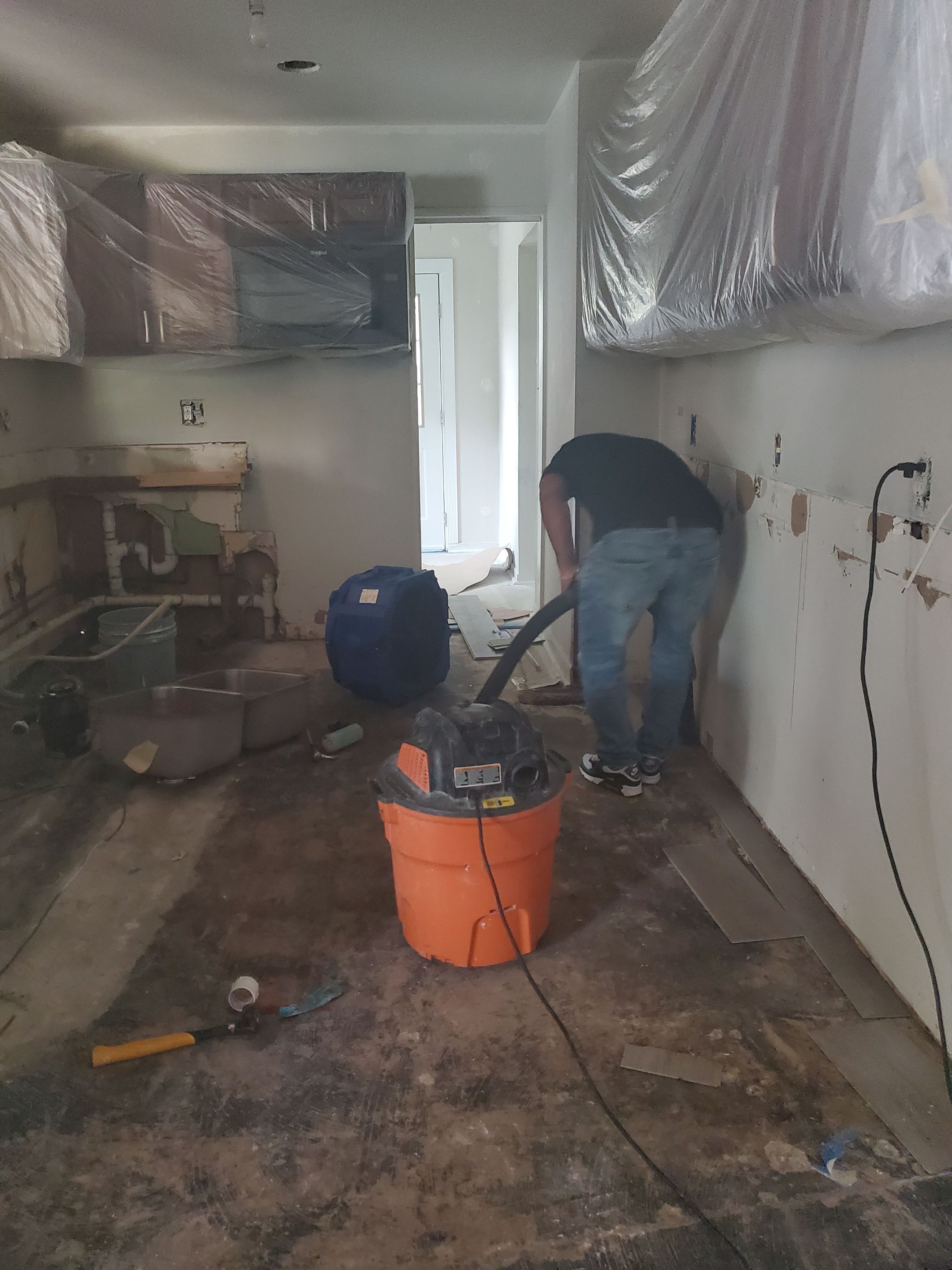 Sanitizing application to flooring after water extraction and carpet removal in Sterling.