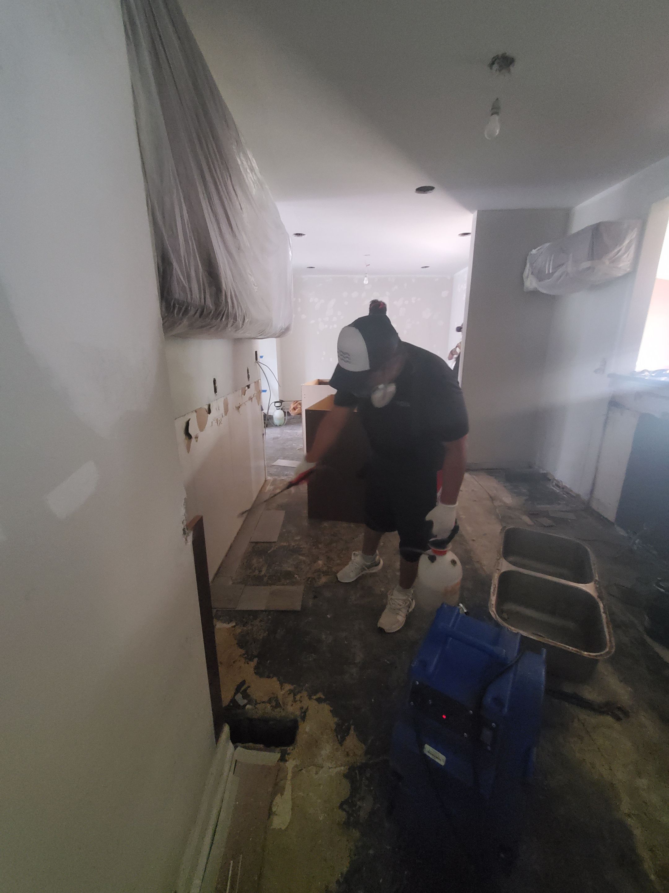 Wet carpet removal underway as part of water damage remediation in Sterling home.