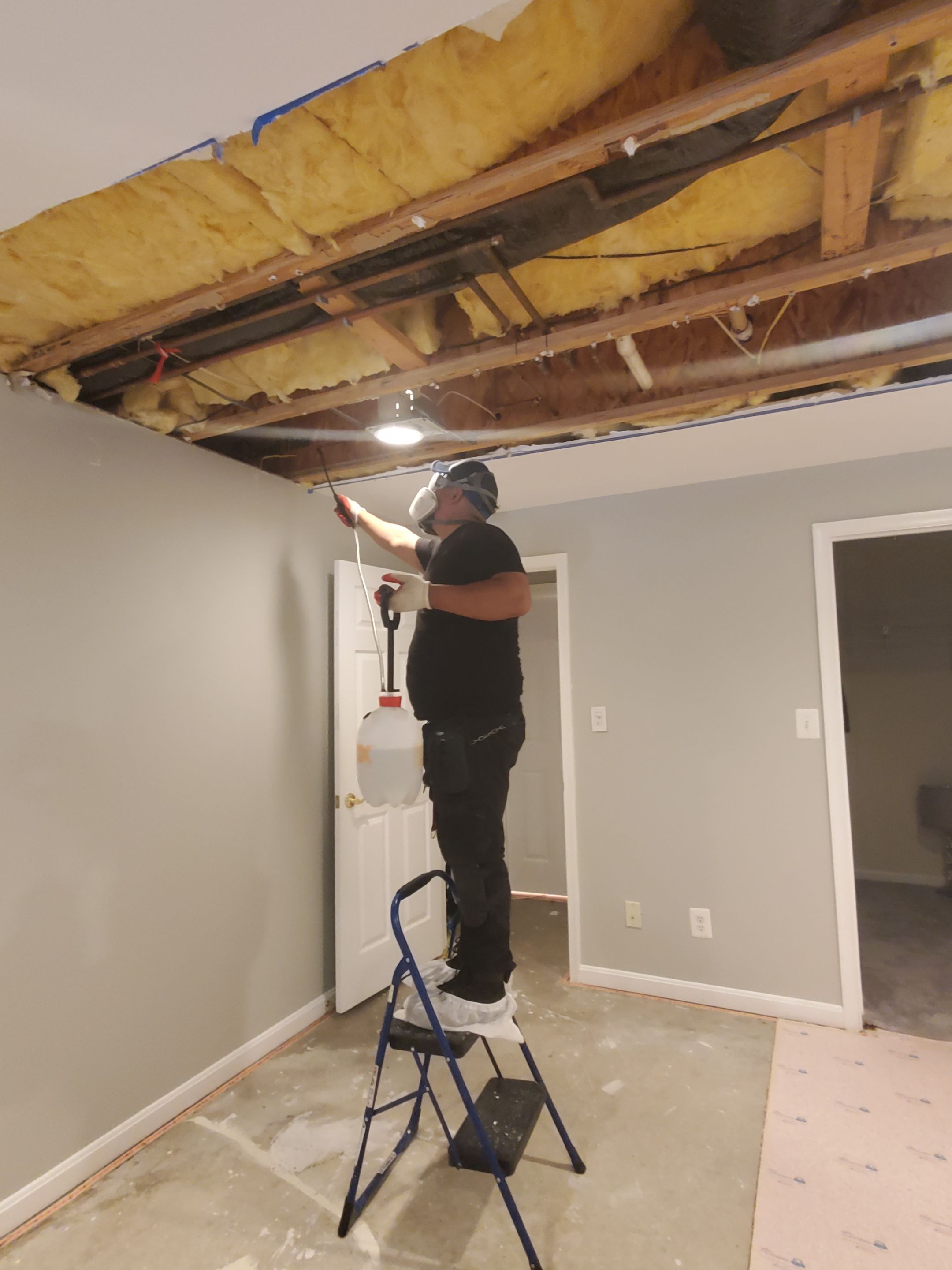 Mid-stage drying setup showing barrier integrity and equipment placement for water damage mitigation.
