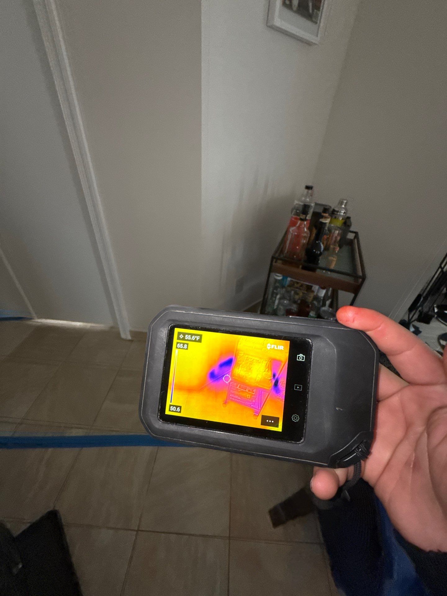 Containment barrier erected during water damage restoration in Fairfax, with thermal imaging equipment positioned for moisture mapping.