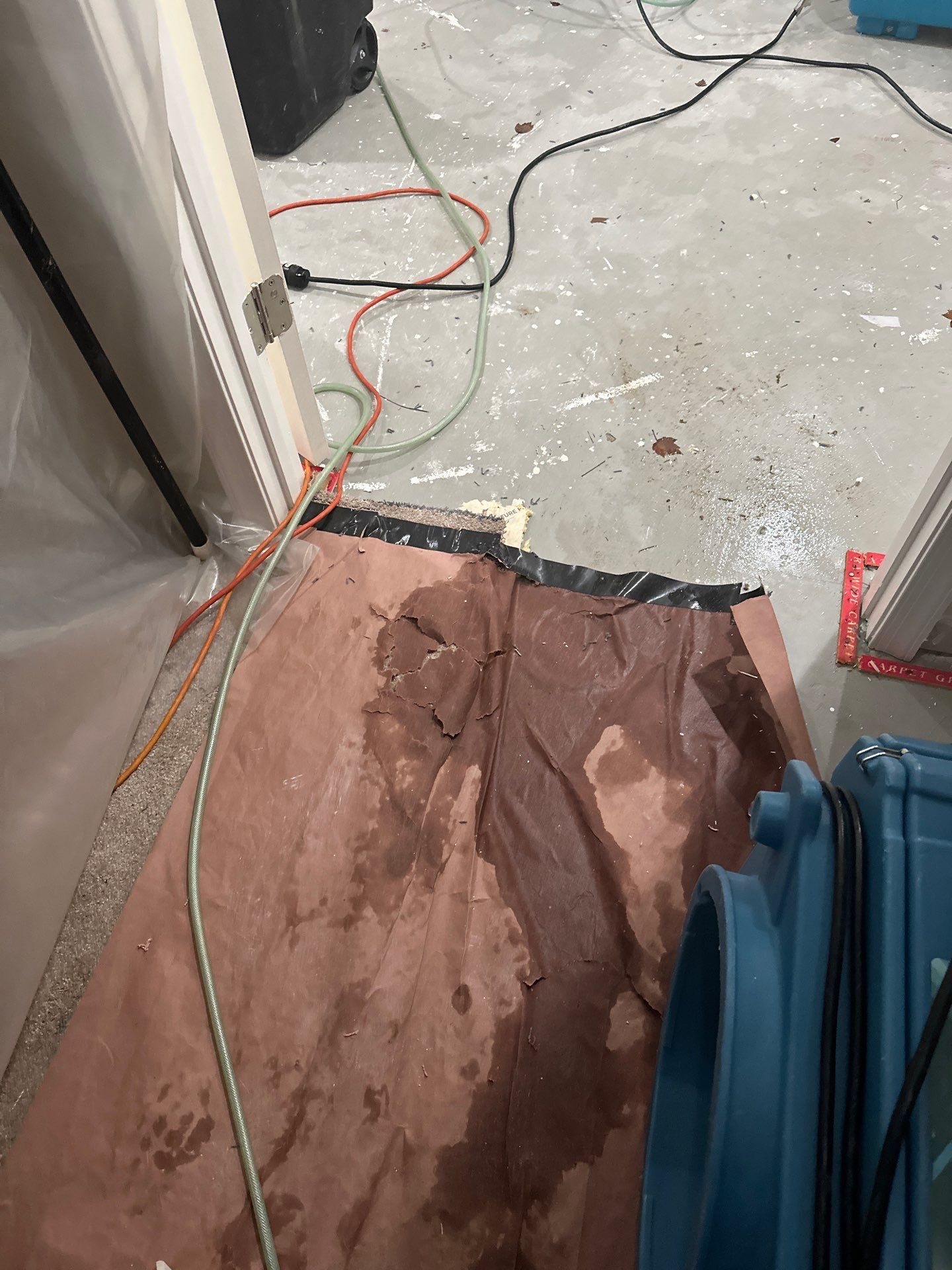 Mid-stage drying progress showing moisture extraction from wall assembly during water restoration work.