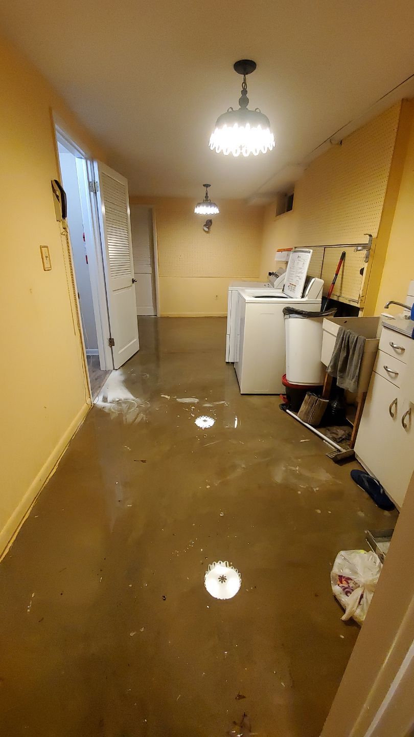 Standing water extraction underway during water damage restoration in Leesburg, Virginia.