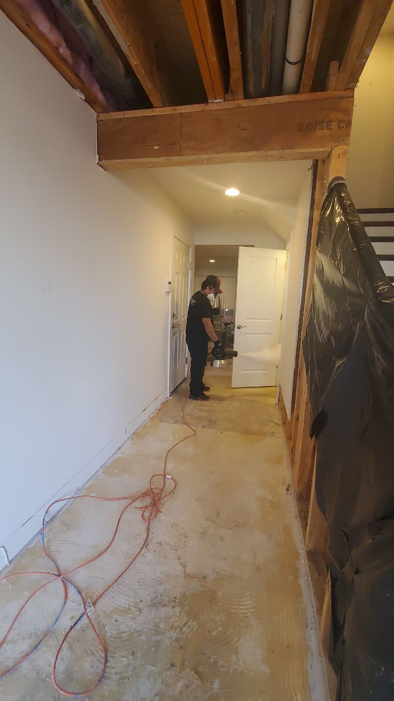 Final inspection of dried flooring and structural areas after water damage restoration in Manassas is complete.
