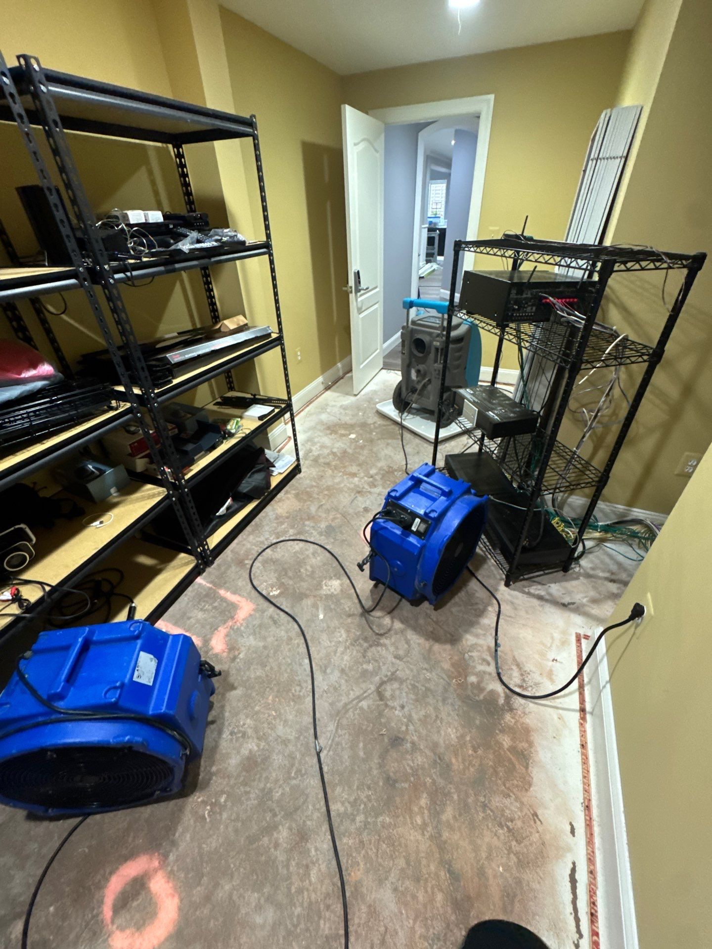 Water damage restoration in progress in Woodbridge, structural drying equipment deployed indoors.