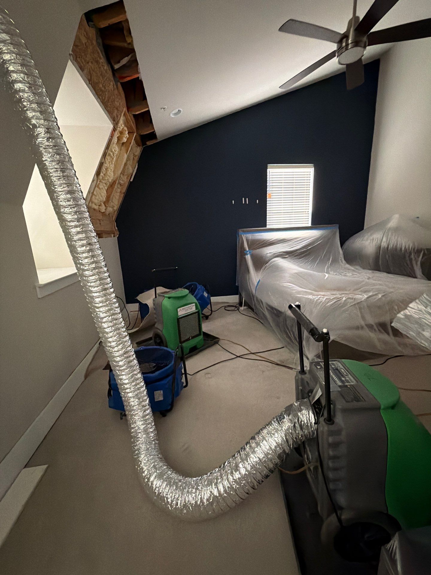 Structural drying in progress using industrial dehumidifiers to extract residual moisture from building materials.